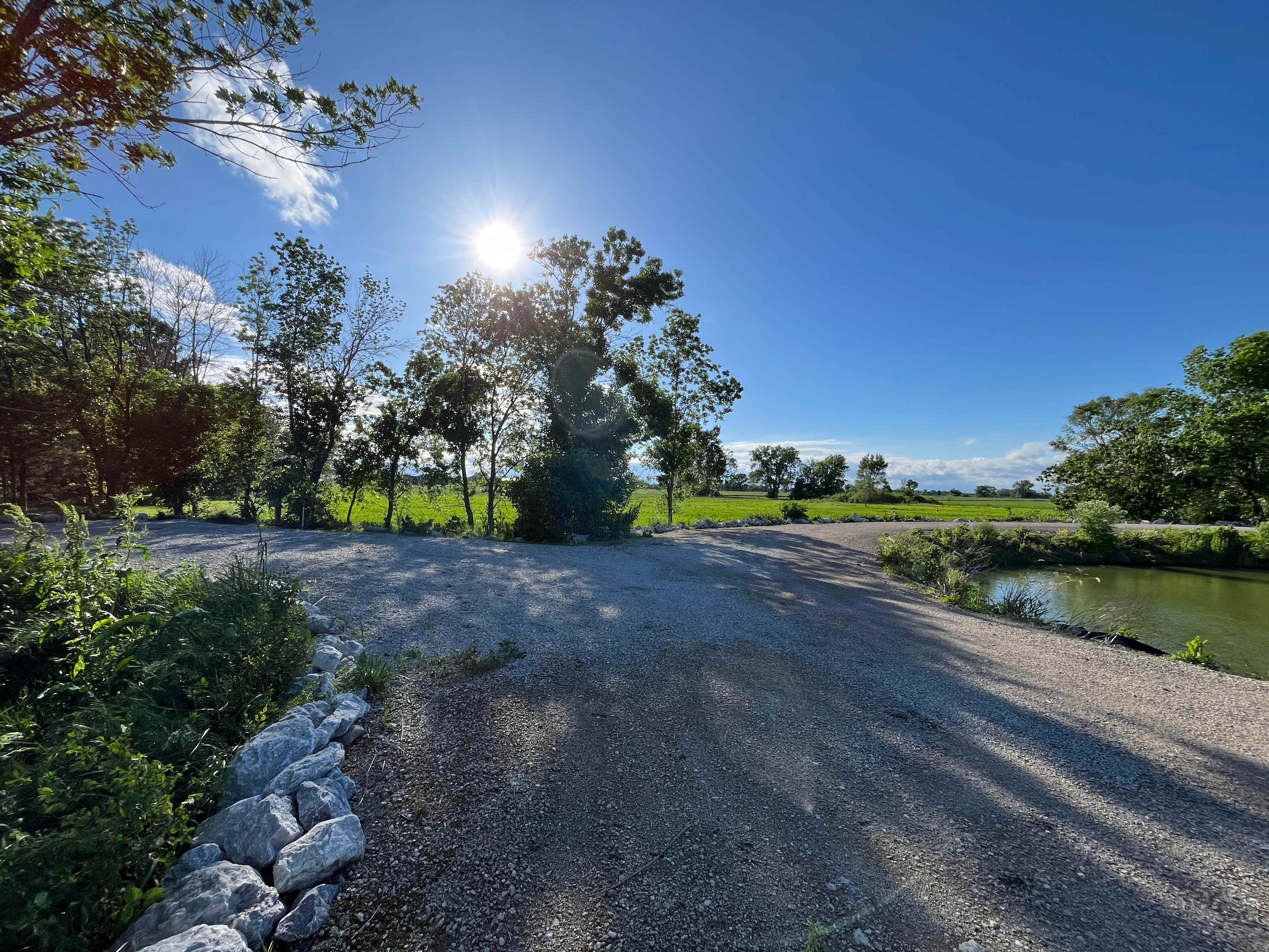 Site 1 - Picture taken in May. You can see this site has direct access to the pond. Please do not block the road. For RV campers - please do not block the road. There Is additional parking steps away from the site. Thanks!
