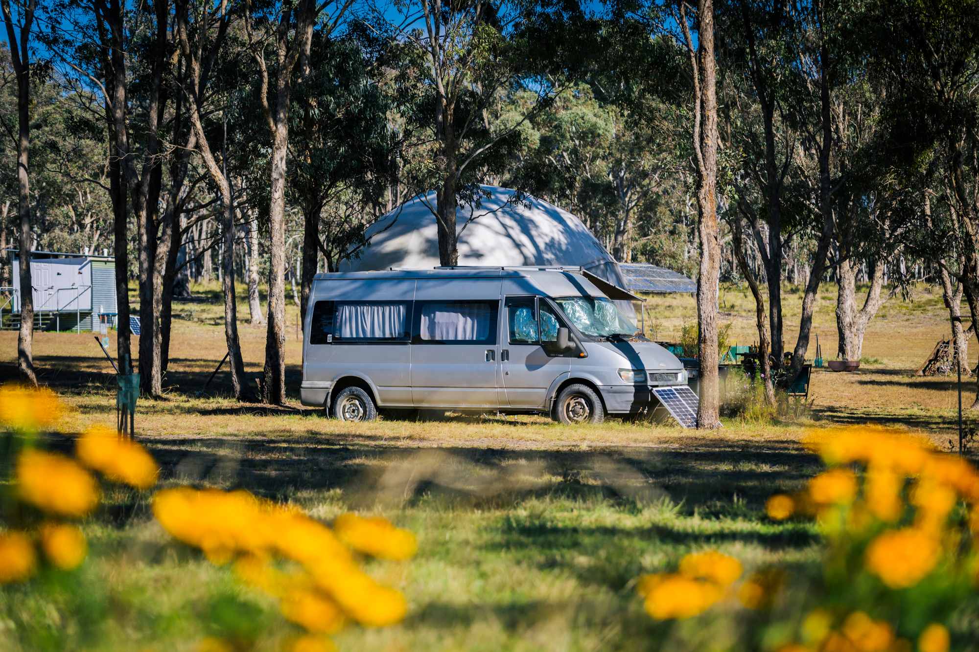 Another van is setup among the trees