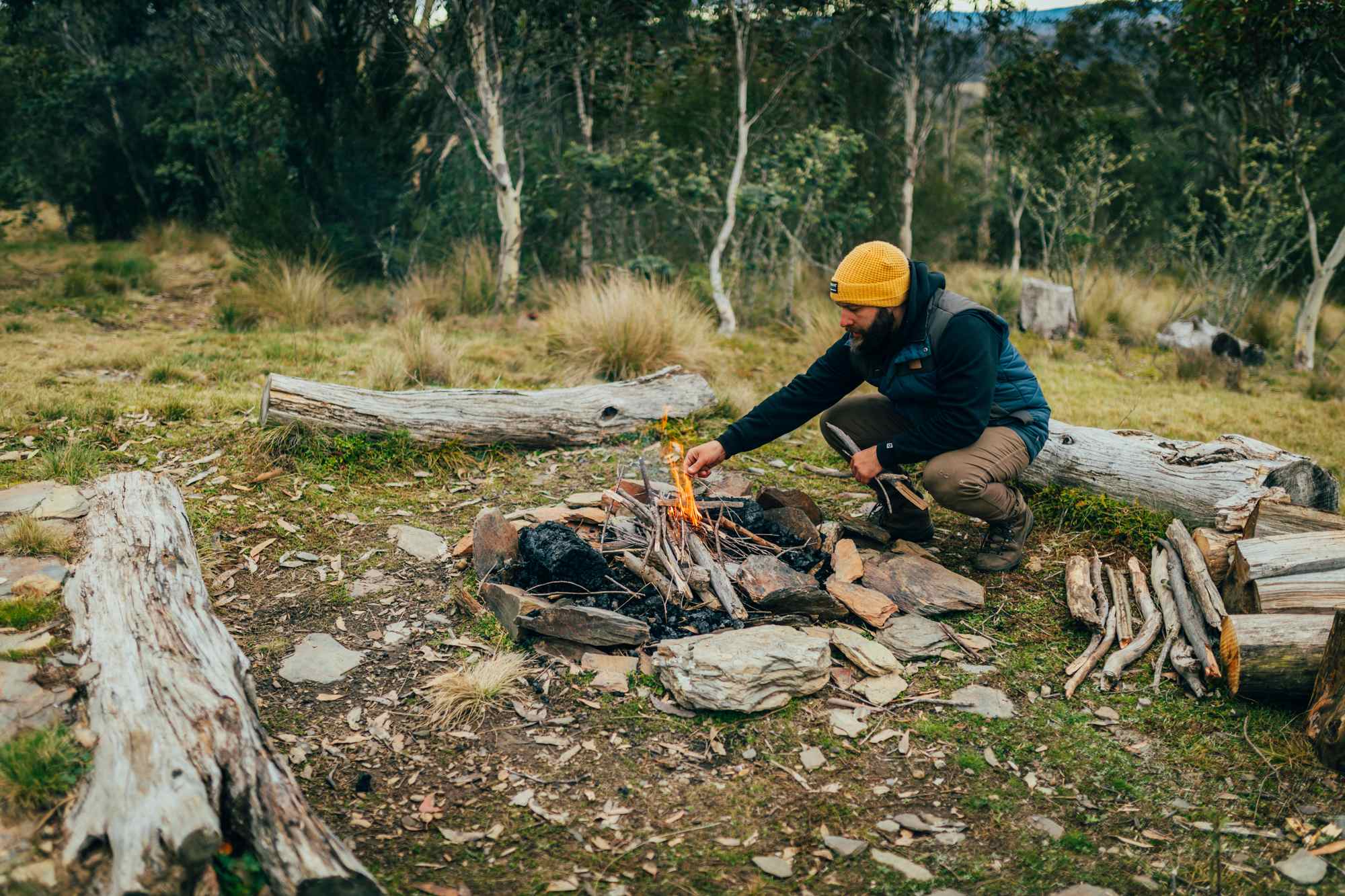 Poking a fire with a stick is one of the life's pleasures