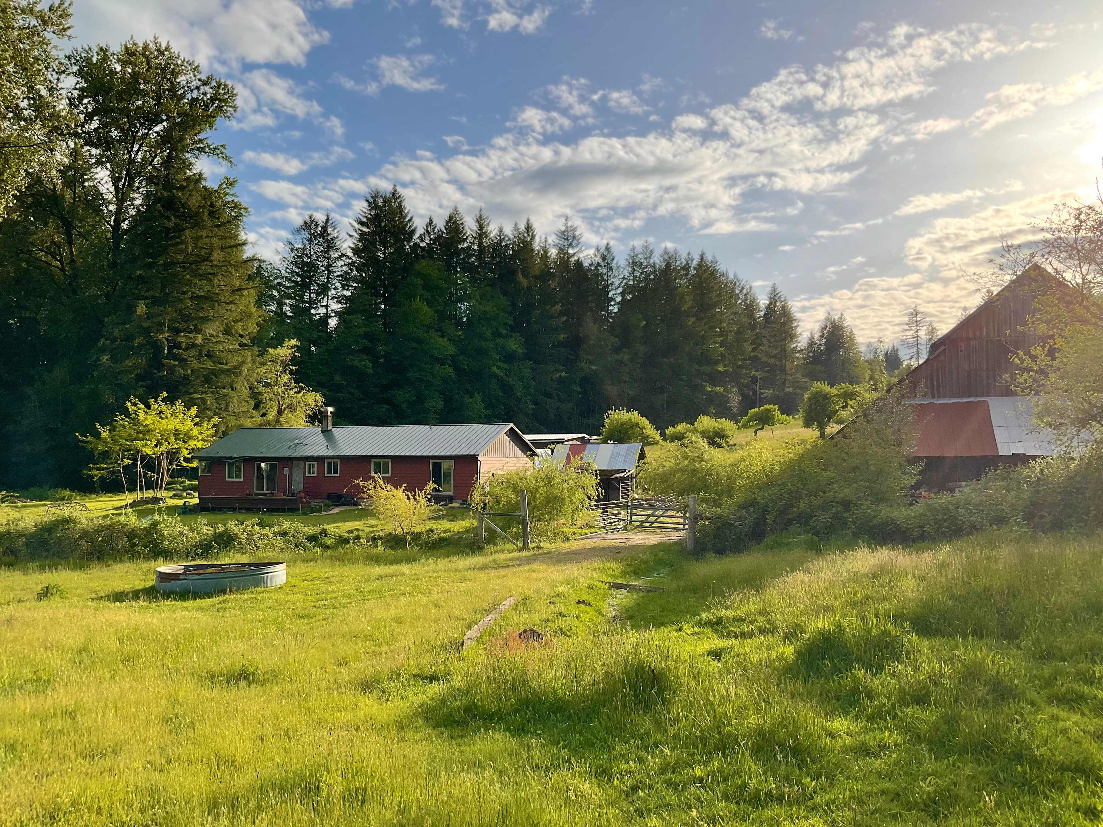 View of the host’s house and barn from the back pasture, where the camping site is.