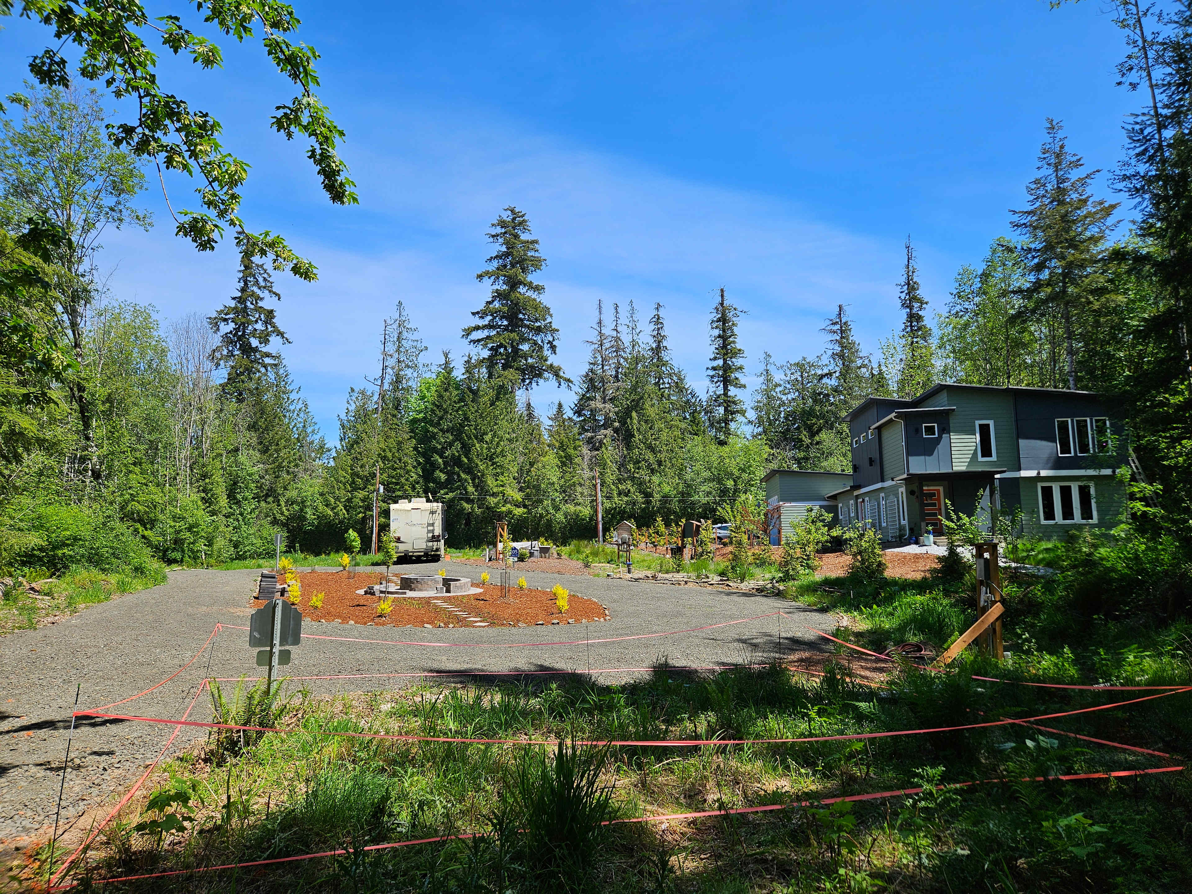 Driveway circle fire pit and RV site viewed from location of future 1-bed/1-bath cottage
