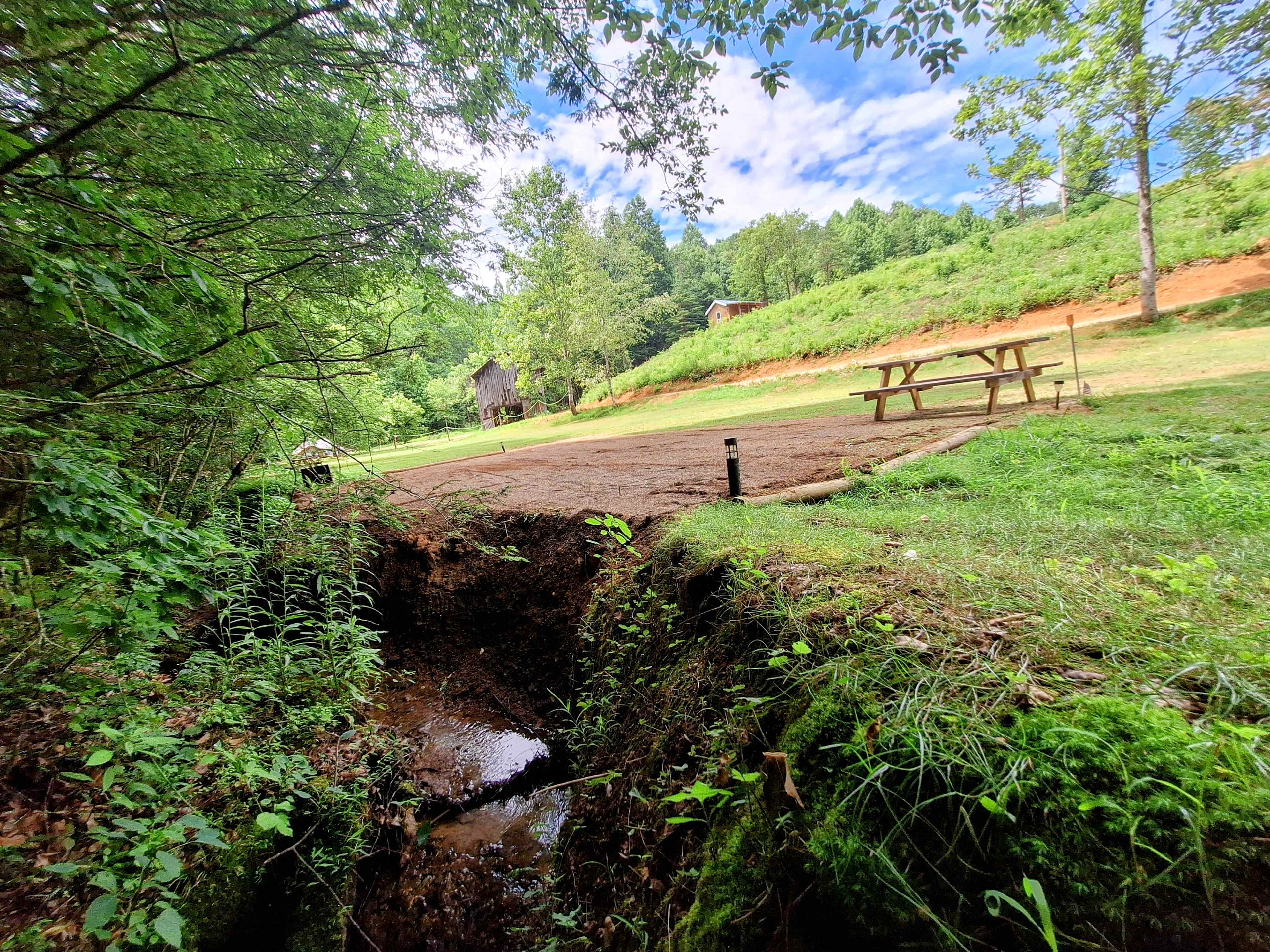 This 40-foot wide site is right by the creek is shaded in the afternoon easy walk to the bath house.