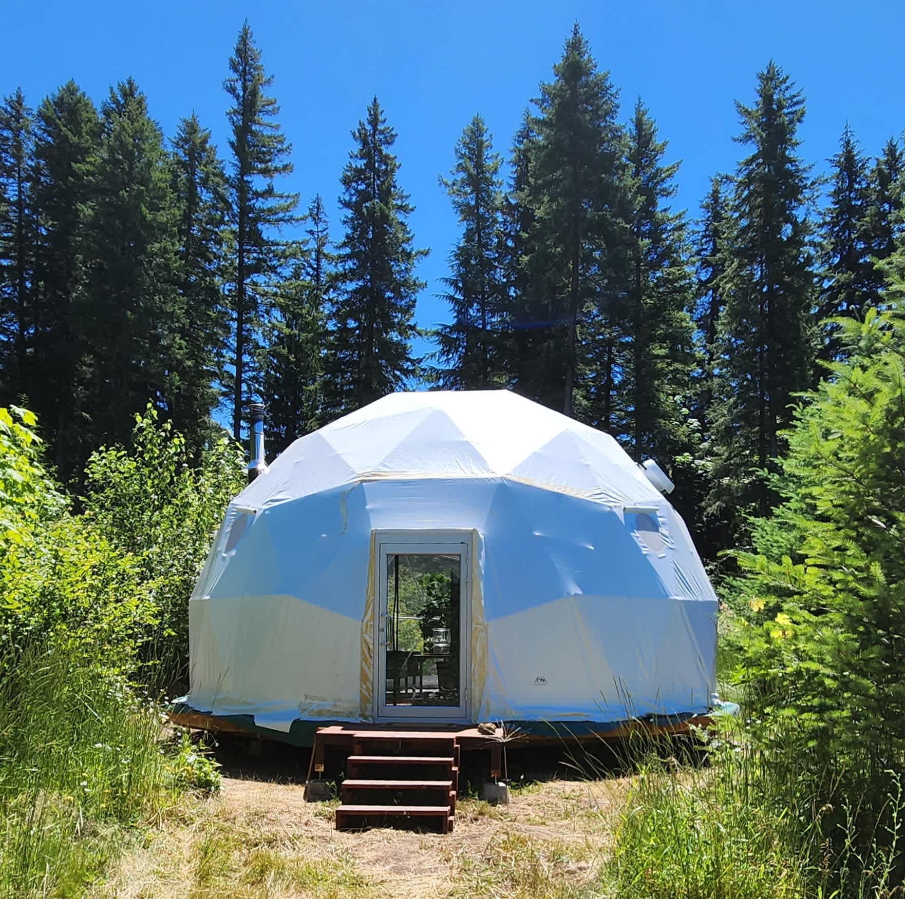 The exterior and front door of our new geodesic dome