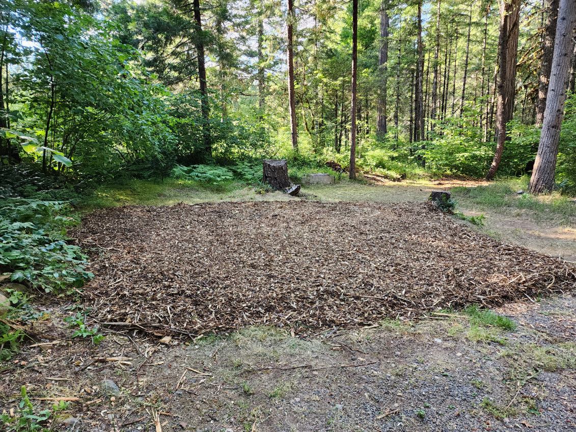 Wood chip bed measures approximately 18' x 18'. Accommodates 1 very large size tent or multiple smaller tents.  