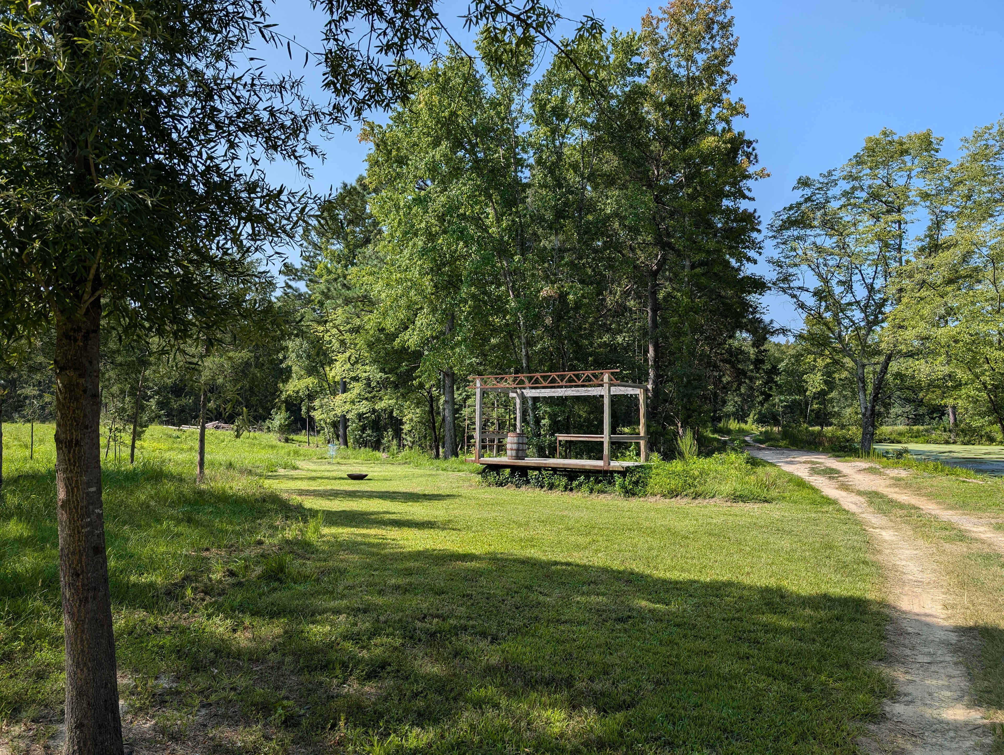 A more zoomed out view with the road and pond to the right.