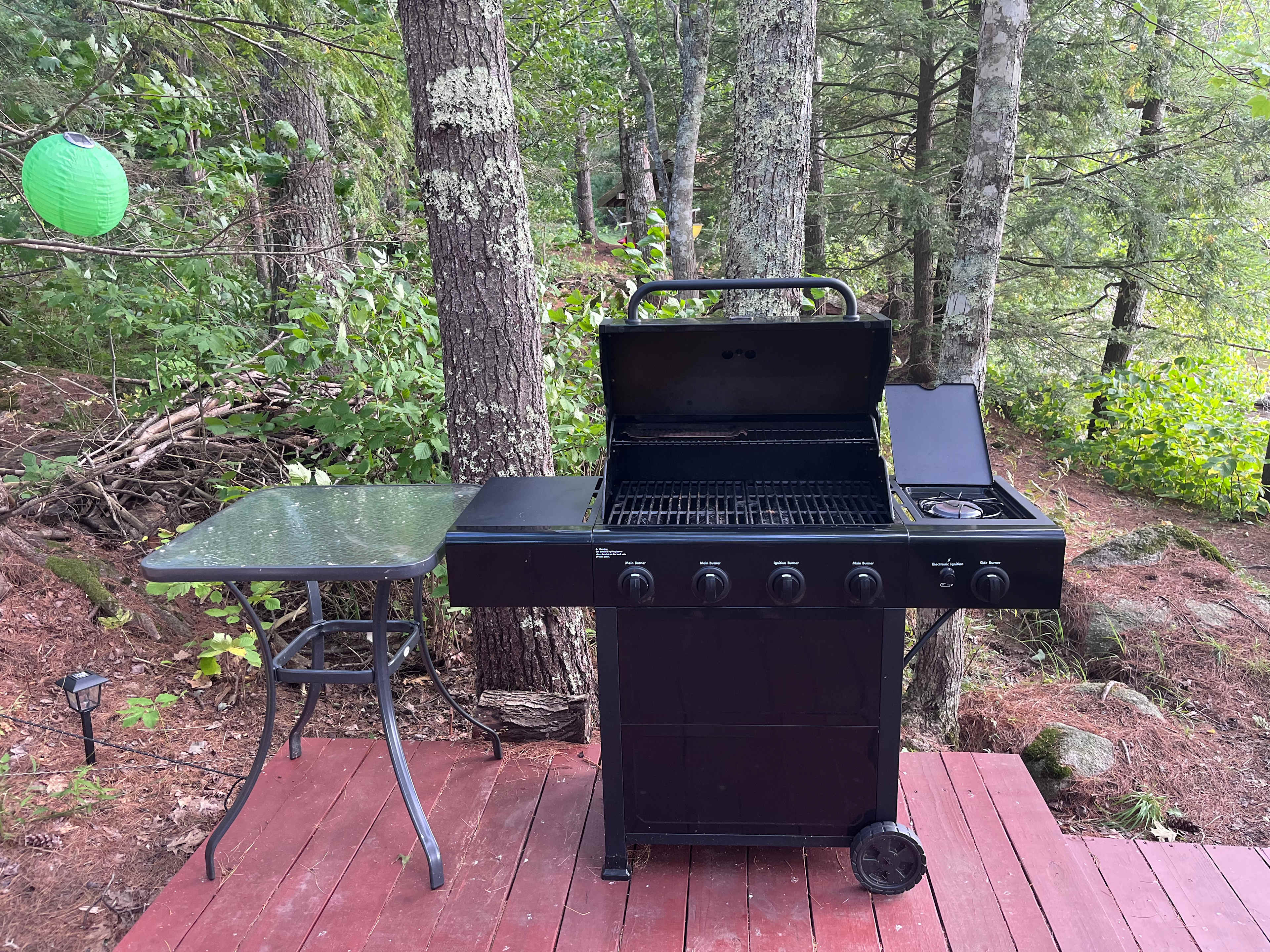 Gas grill with burner (propane included with site rental).