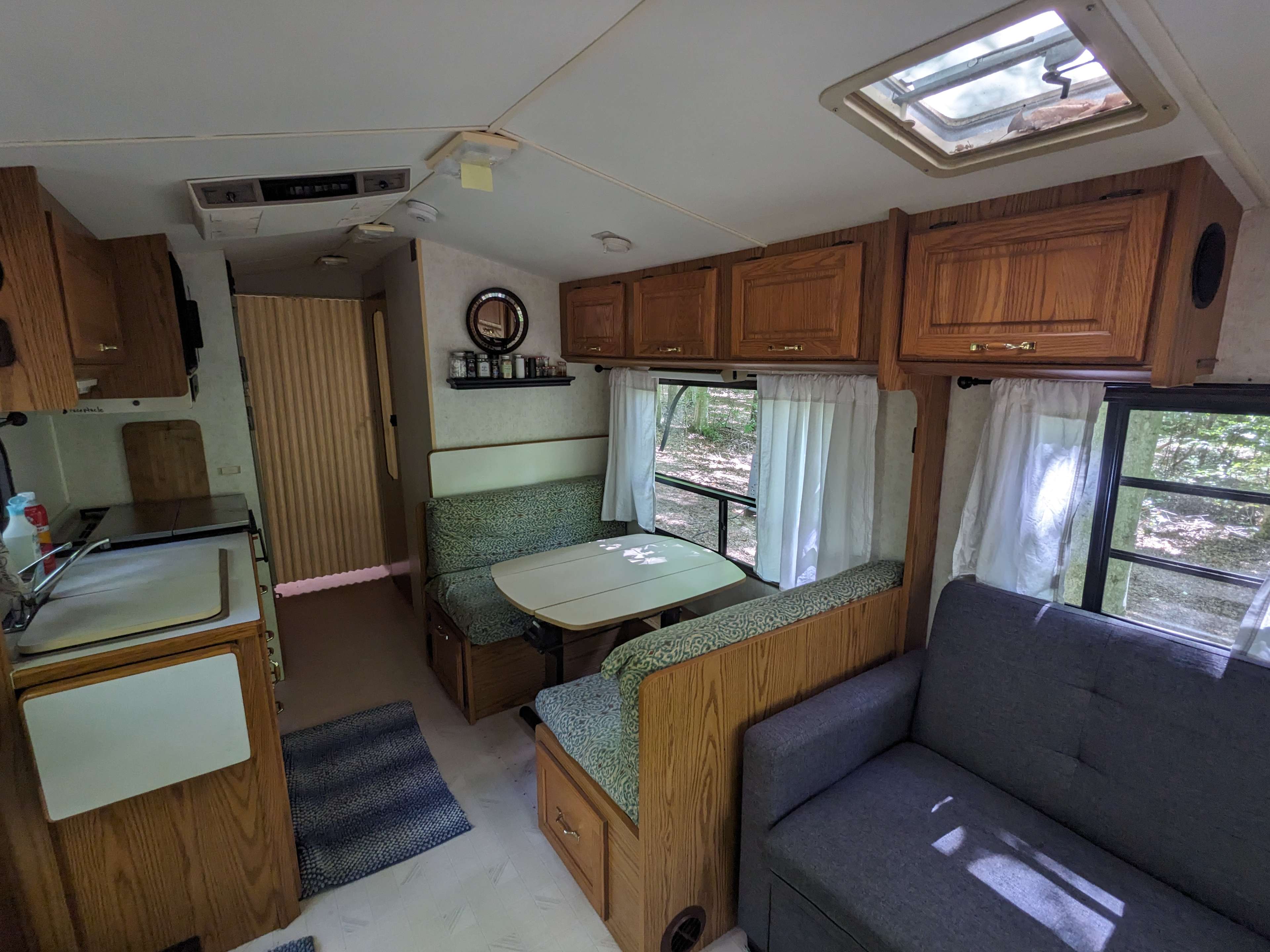 The bedroom has a privacy screen and all the windows have curtains.
