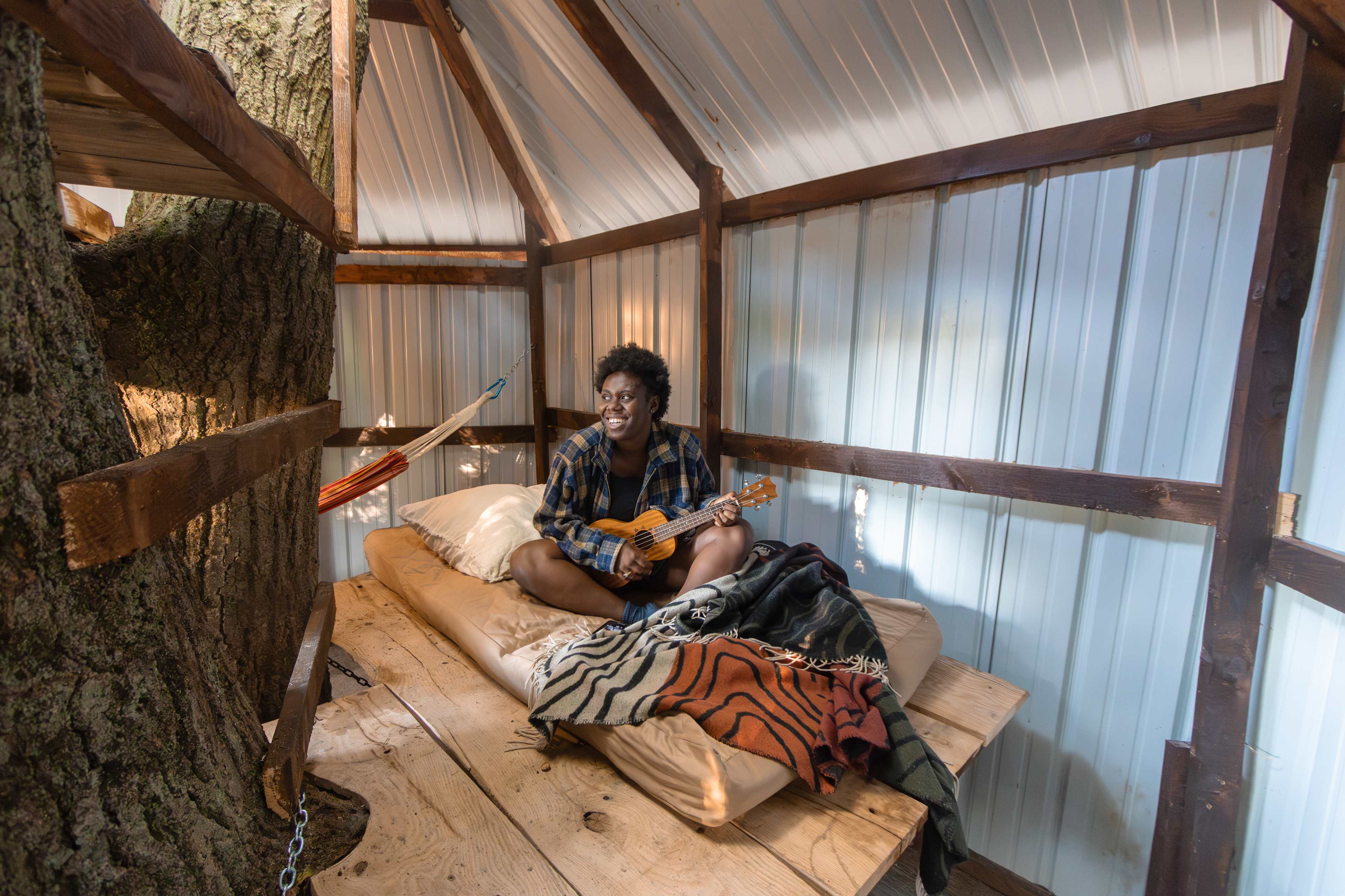 Playing ukulele from bed in the treehouse.