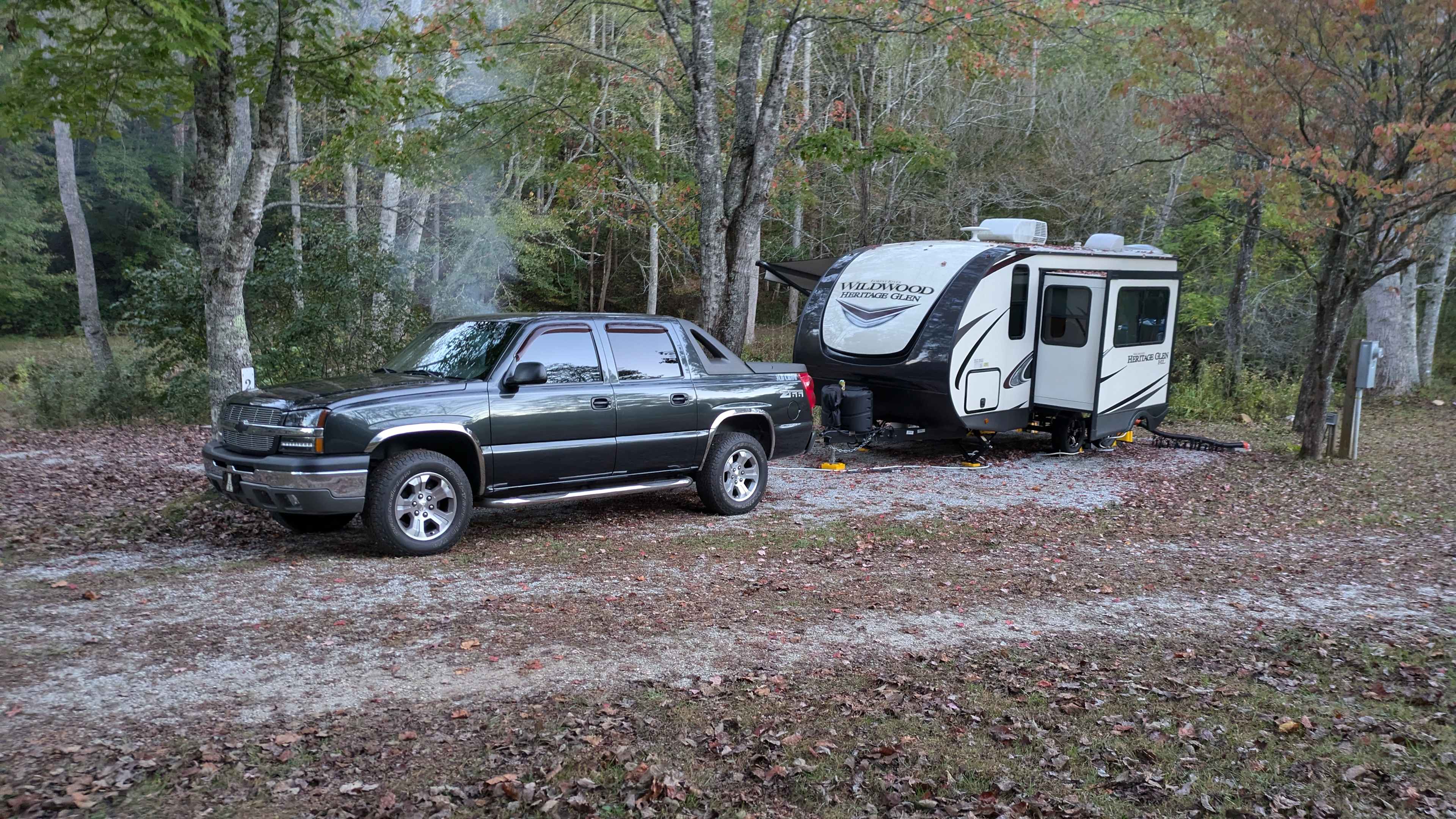 Gravel pad...but all good. Bring an extra hose for fresh water. 