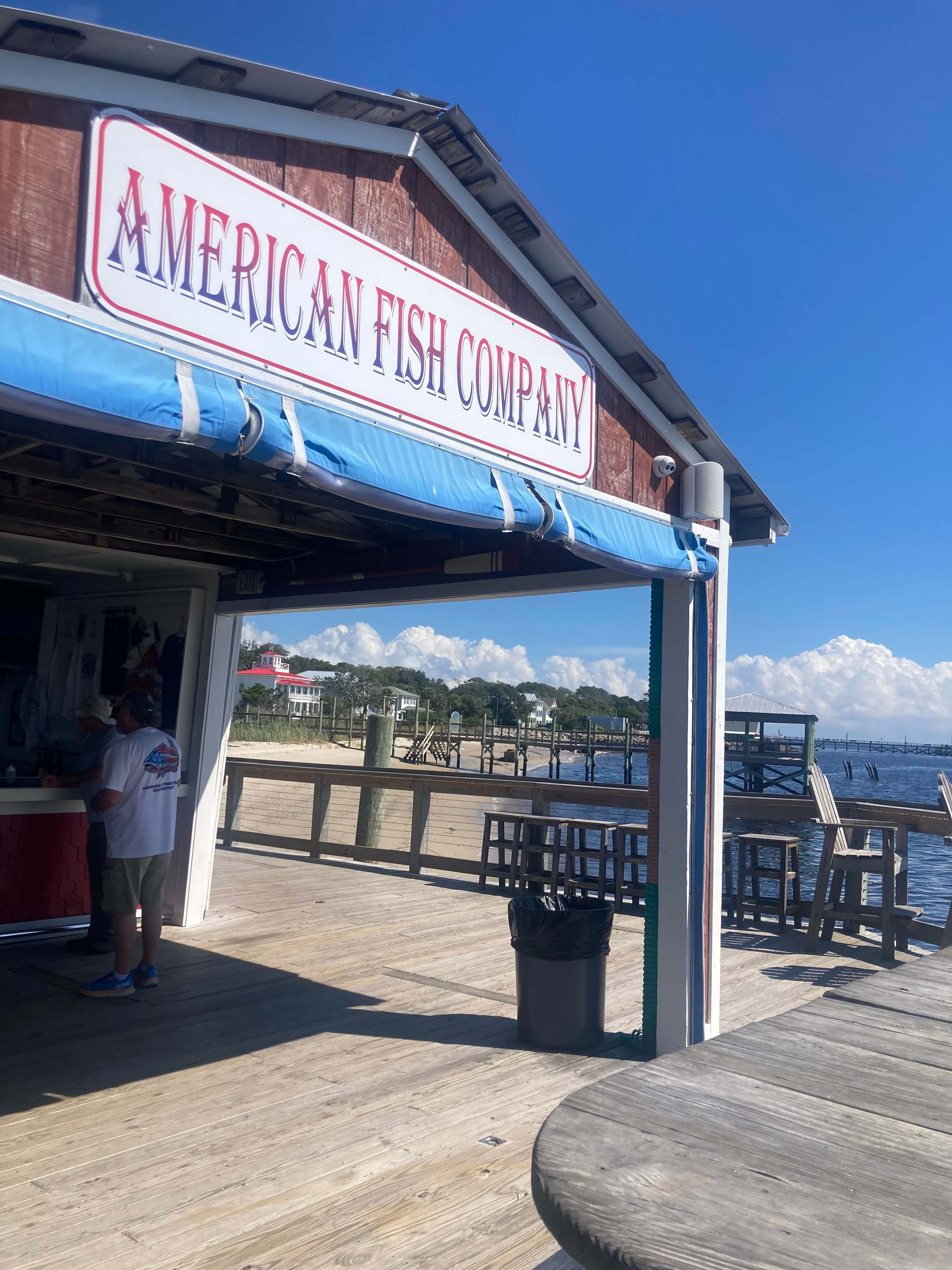 Watch boats go by and dolphins from the American Fish Company in Southport