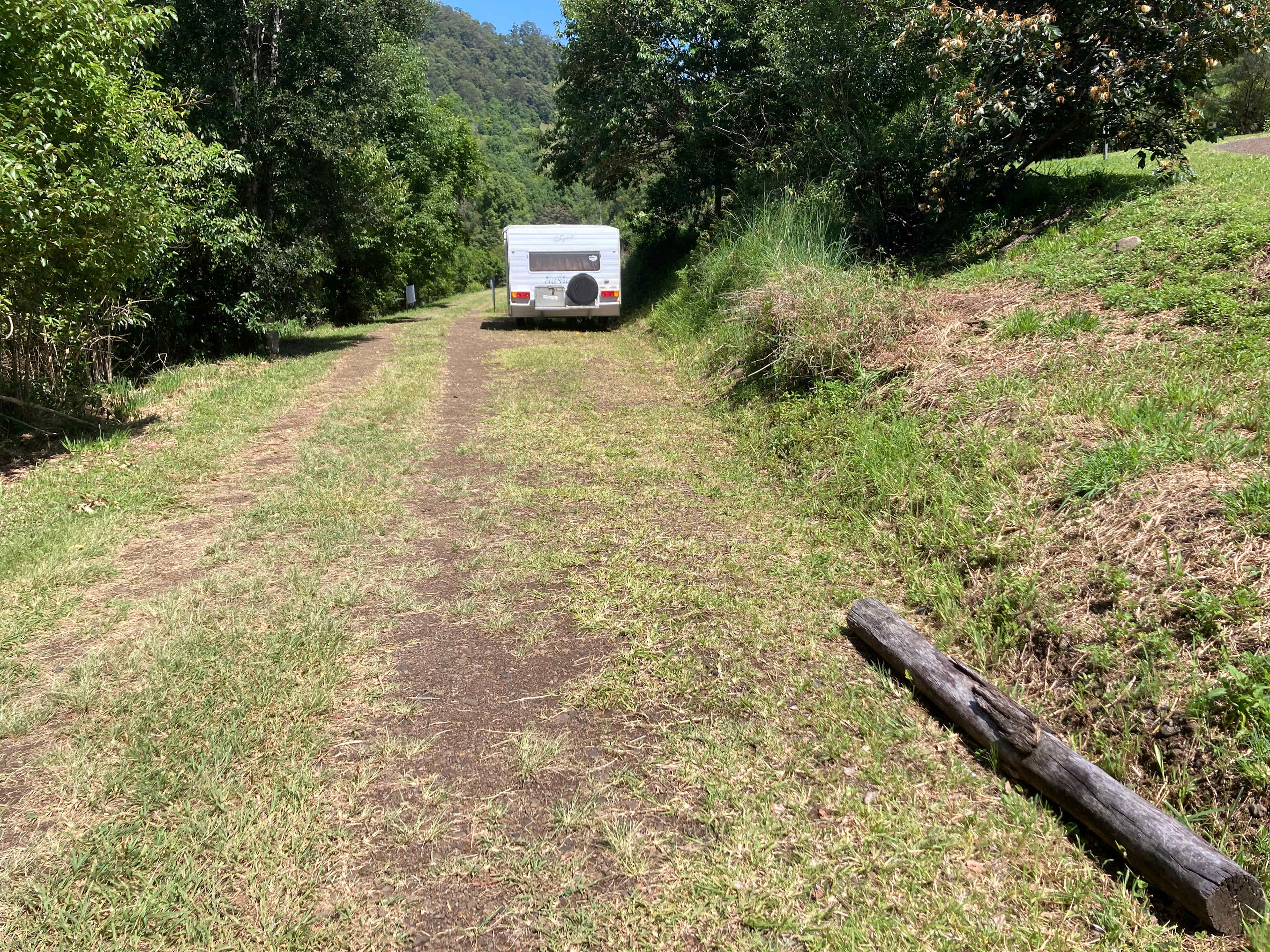 This track leads to the Tent Sites and Owner’s dwelling. Communal parking is here beside the track where it is wide. Caravan has its own carpark on the other side, and it’s own track to the shared shady creek spot below.