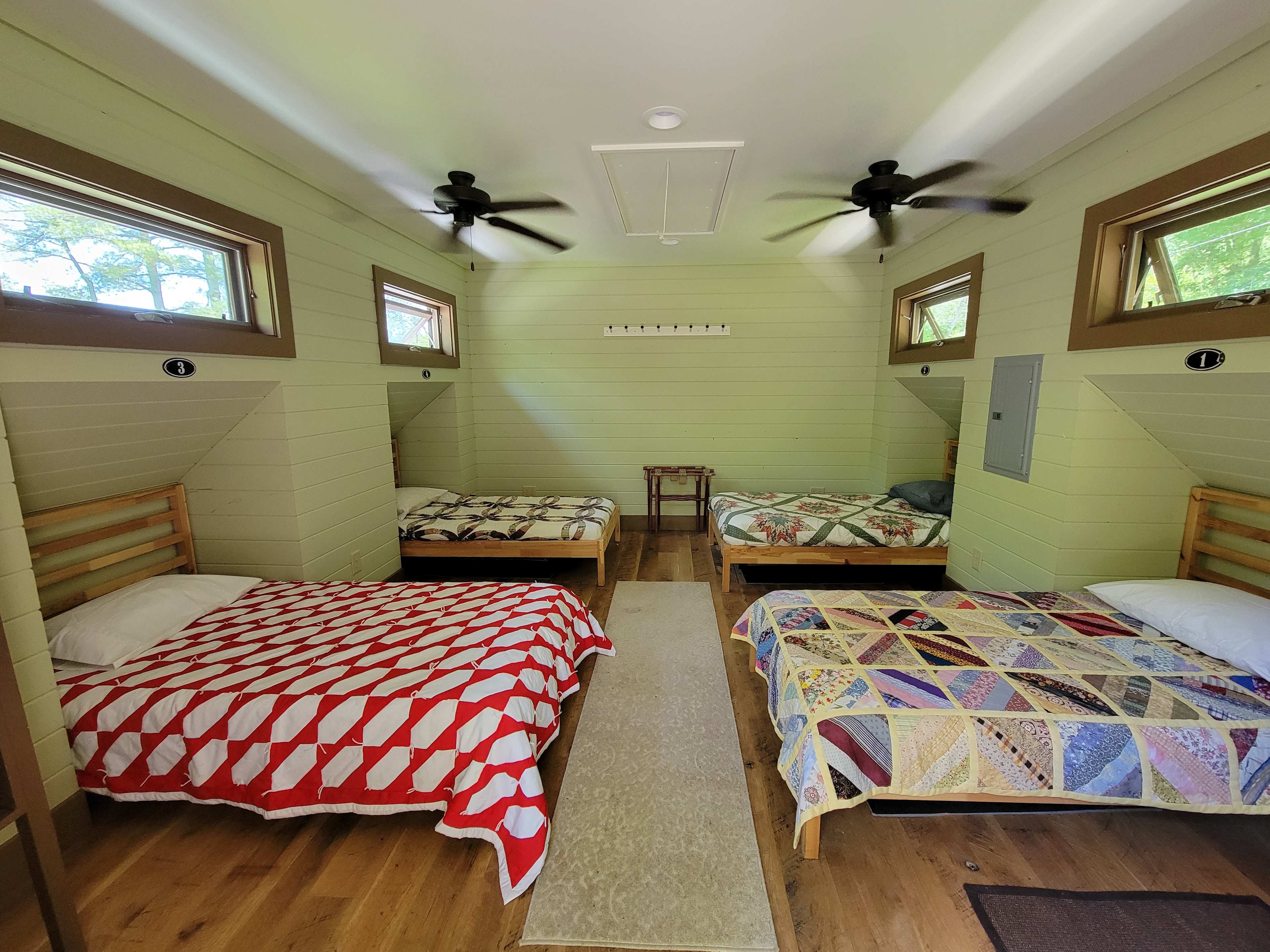 The Bunk Room is a simple room that sits above the bath house. This room has four twin beds - linens provided. This room has fans for the warmer weather and a space heater for colder months.  Reservation is for the whole room.