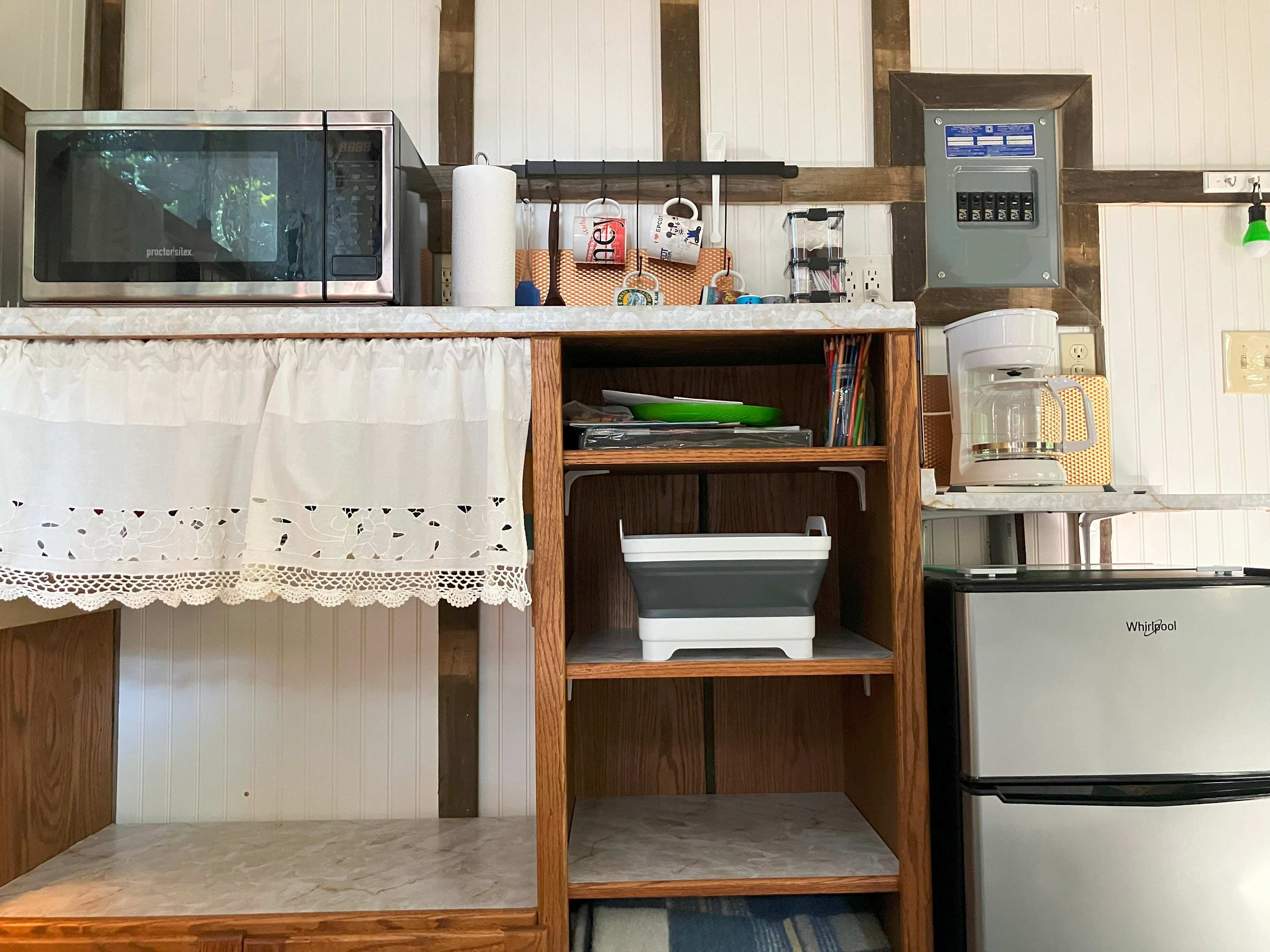 Kitchen area is fully stocked with dishes, pots, silverware.
Coffee Pot, coffee, sugar, creamer, Tea Bags included.
Microwave and Mini-Fridge w Freezer included.
5 gal. Drinking Water included.

Bring your own Food. 