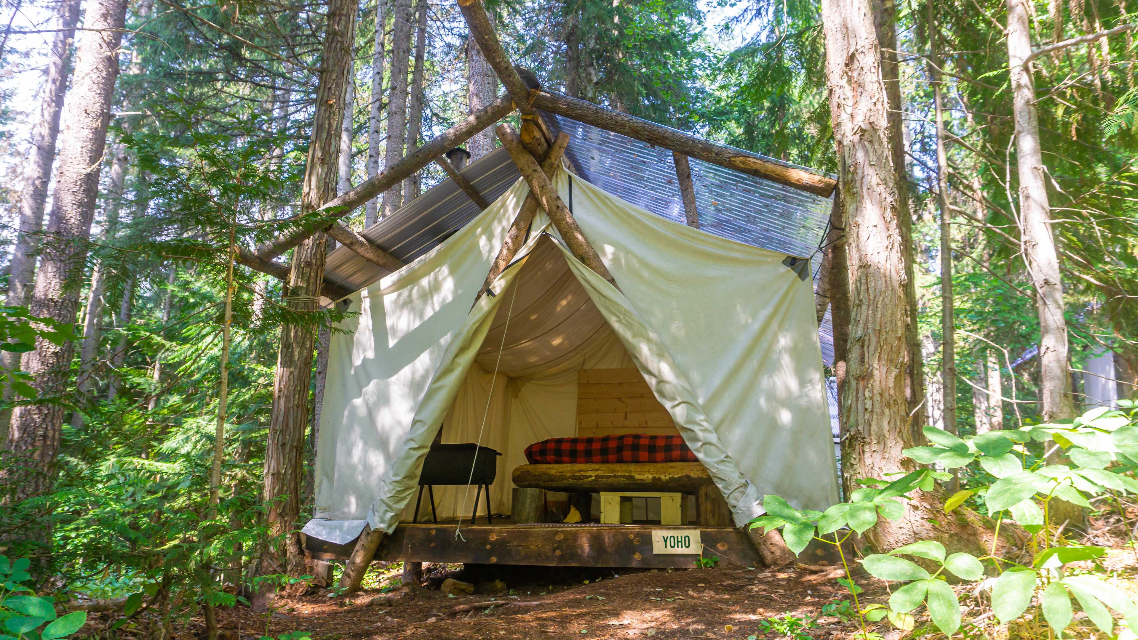 Double occupancy tent with a cozy queen log bed, super warm duvets, and a wood stove to keep you toasty!