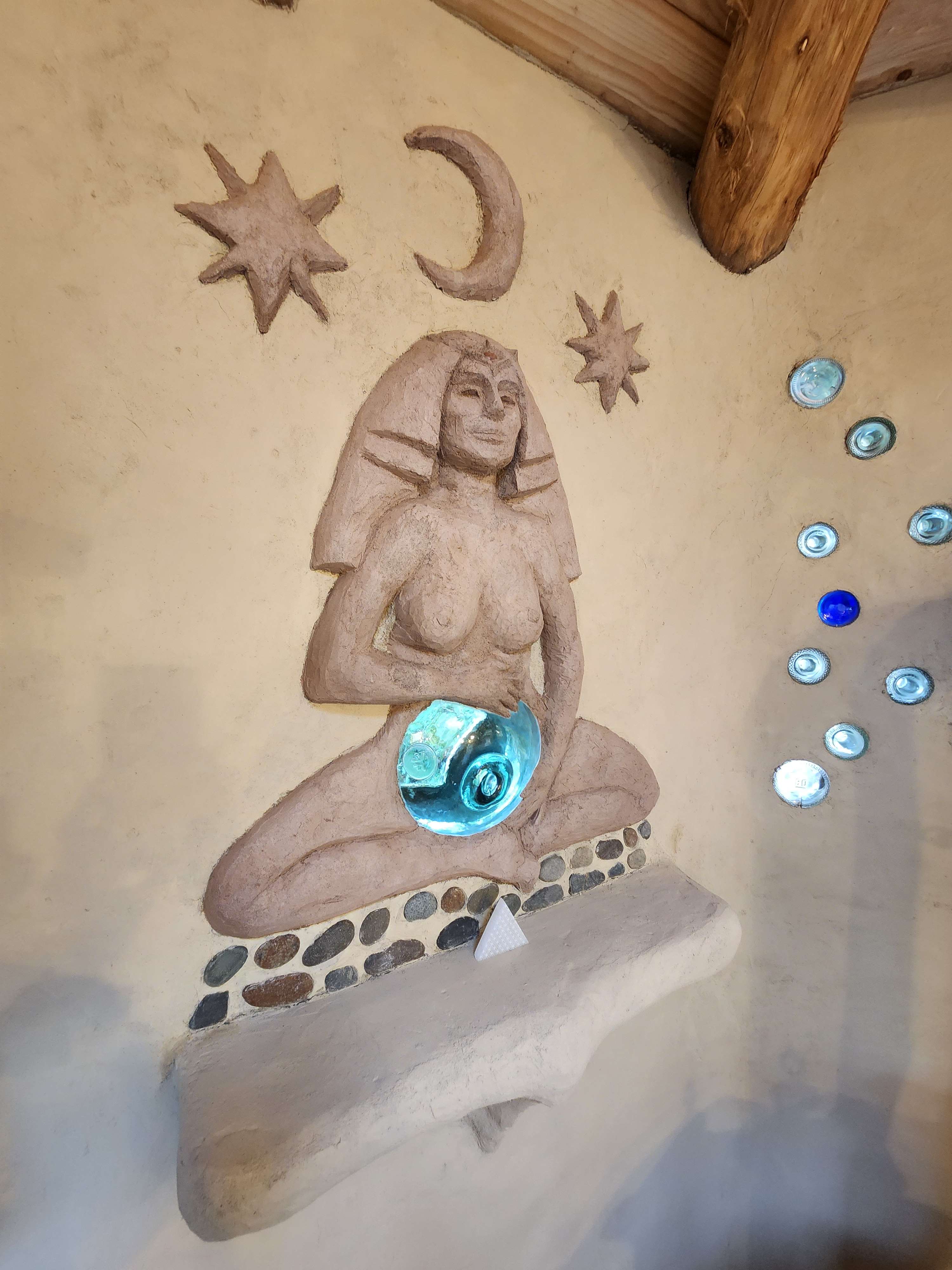 Beautiful mother goddess with an antique glass fishing flat as a belly. It's she lovely.