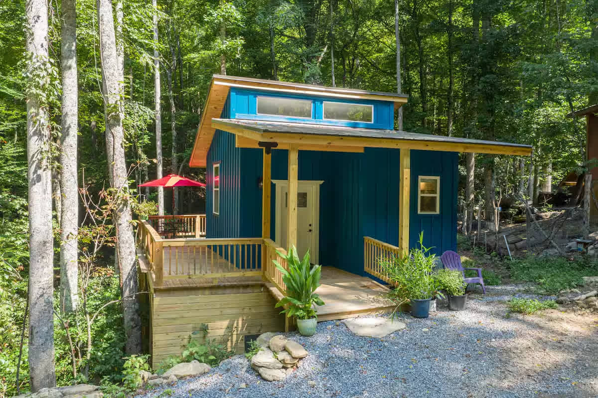 This tiny home lives like a Treehouse high above mountain creeks and nestled in a fairy-tale forest. 