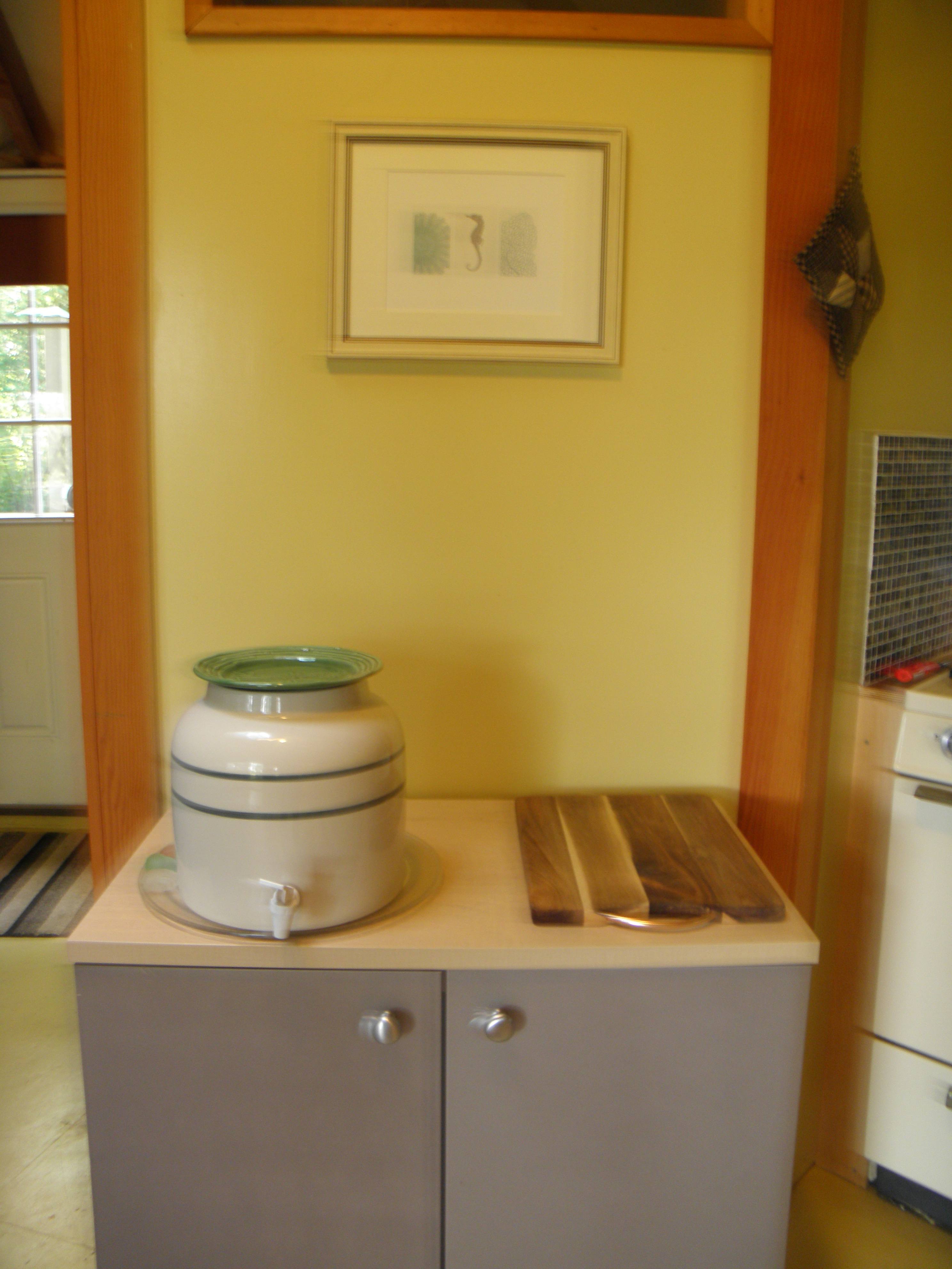 The tap water is from our well that has a bit of iron in it, so filtered drinking water is provided in this crock, with more below in the cabinet.