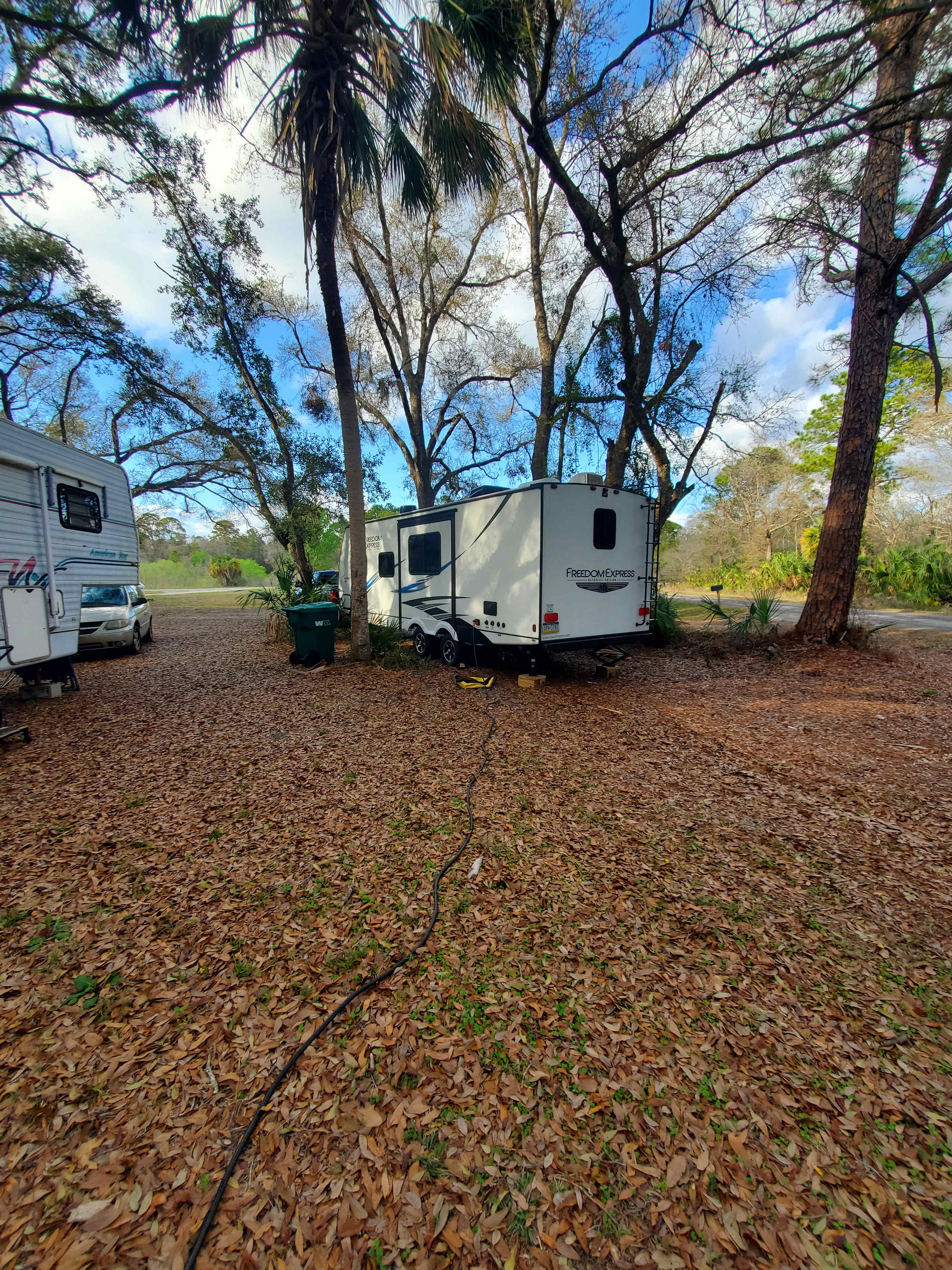 Parked between the trees, much more level than the spot near the utility tower
