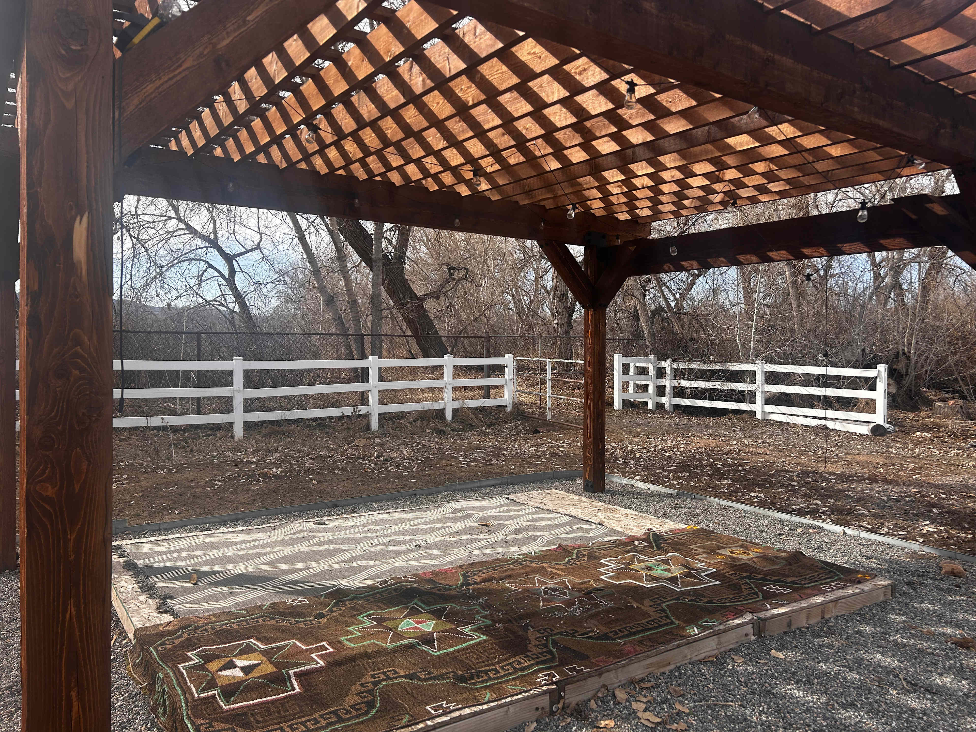 Tent site under the pergola. Behind the fence lies open space with animals, birds, etc!  (wood platform no longer on site).