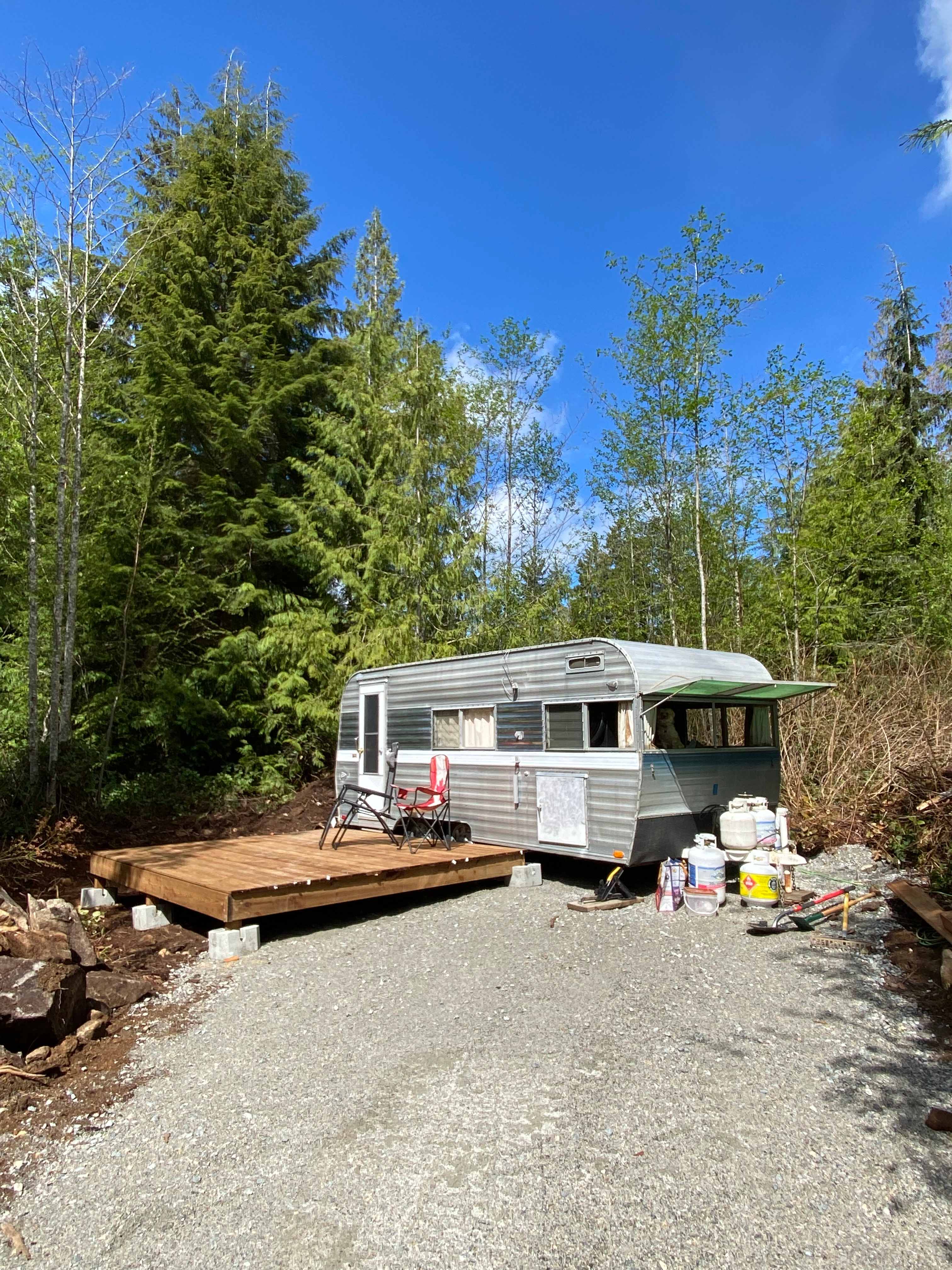 Gravel driveway with deck suitable for pitching tent. Shown here with a small RV.