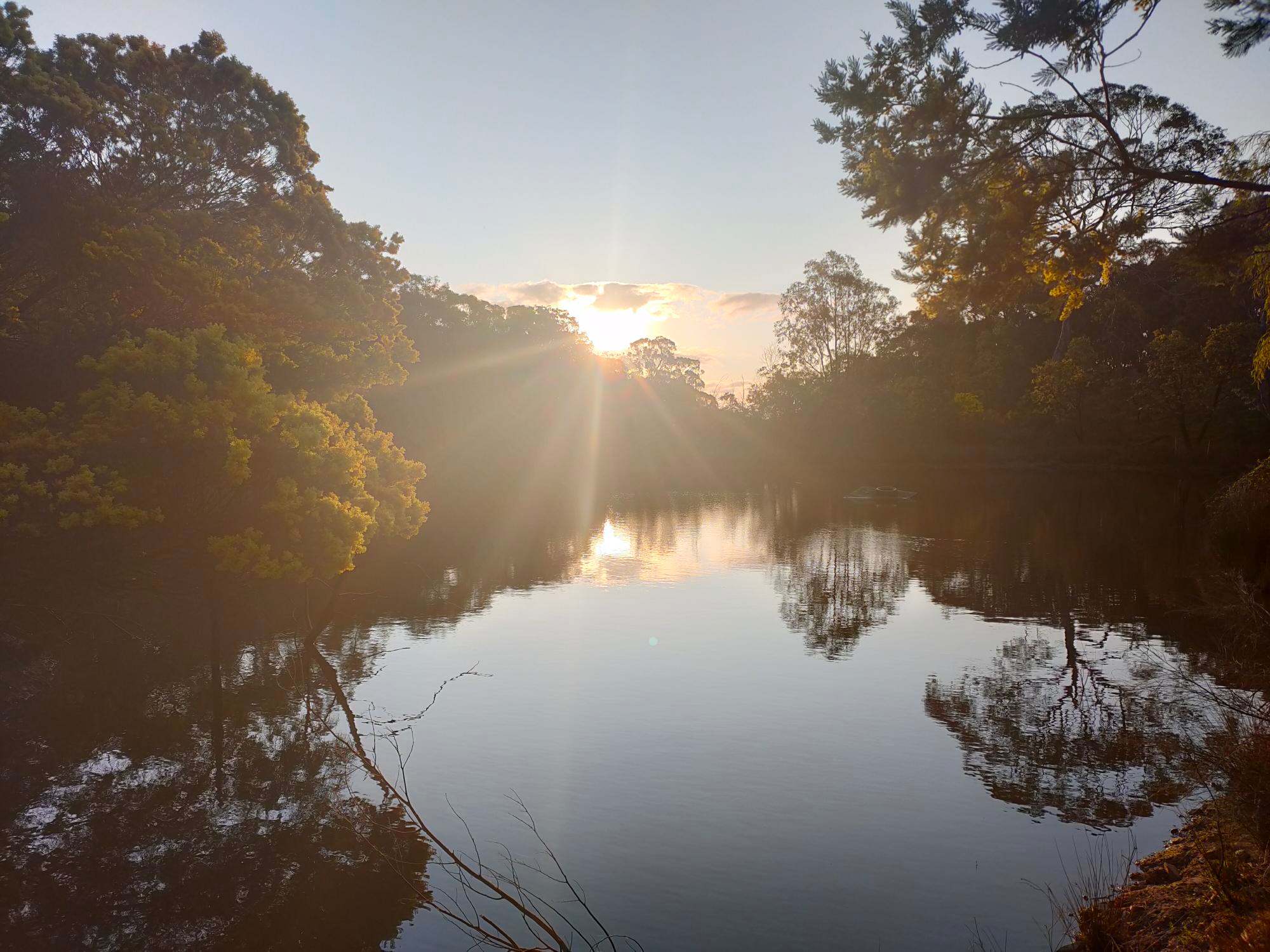 The sun sets over the dam, every day is different 