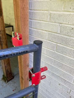 gate latch- pull **UP** not squeeze or pull forward on **ONE** of grey metal latches then swing forward or back gate depending on which latch you pulled up. this is very secure so your furry friend can play without leash