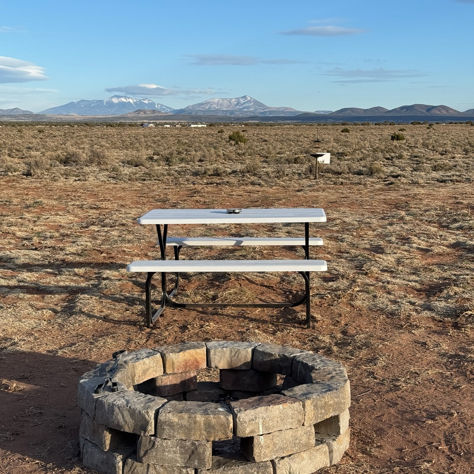 Picnic table and fire pit on site.
