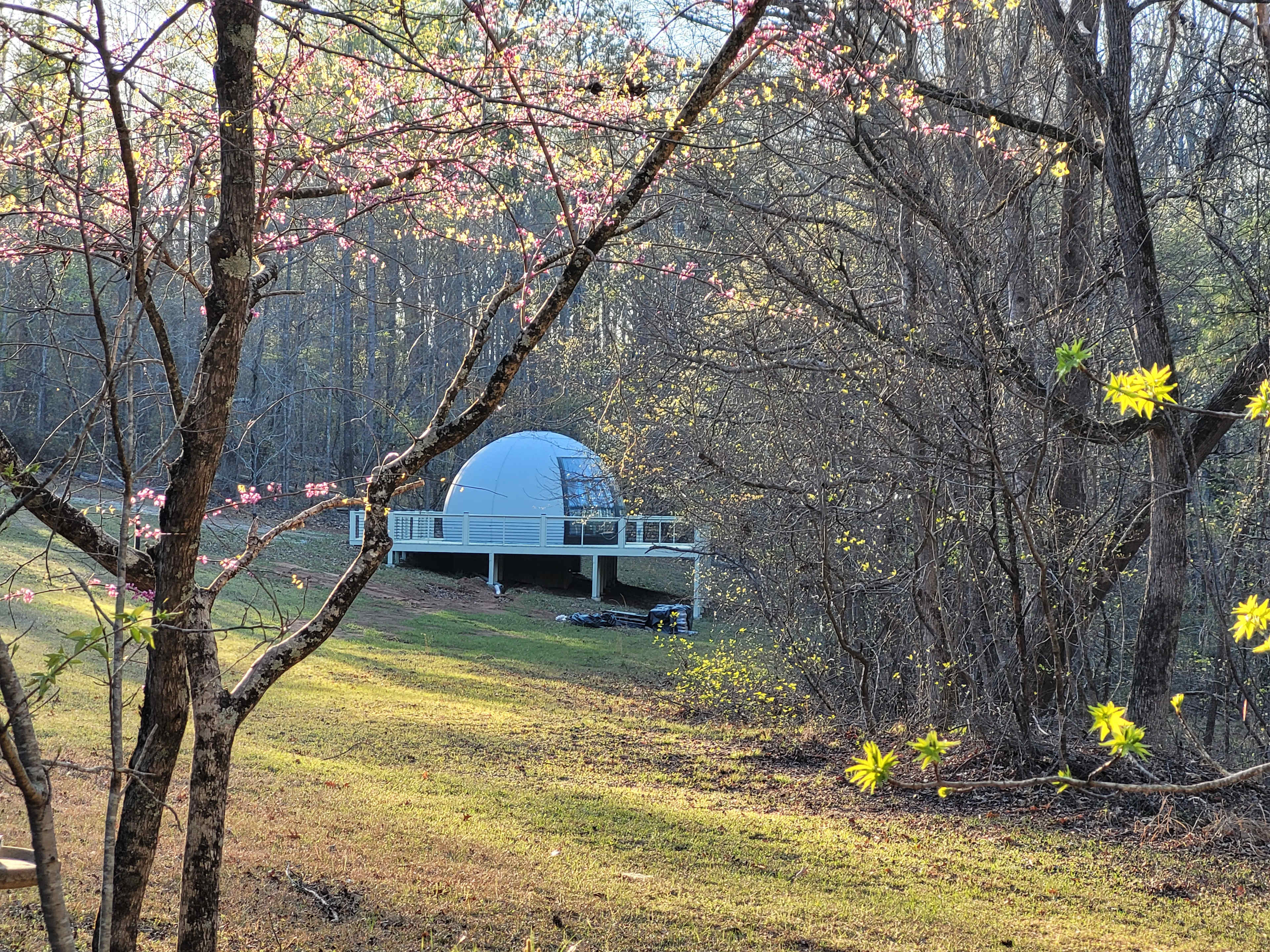 Whispering woods is a Totoro Themed dome that is situated on a private portion of the 100 acre property with a beautify view of the woods from the 3 floor to ceiling glass panels.