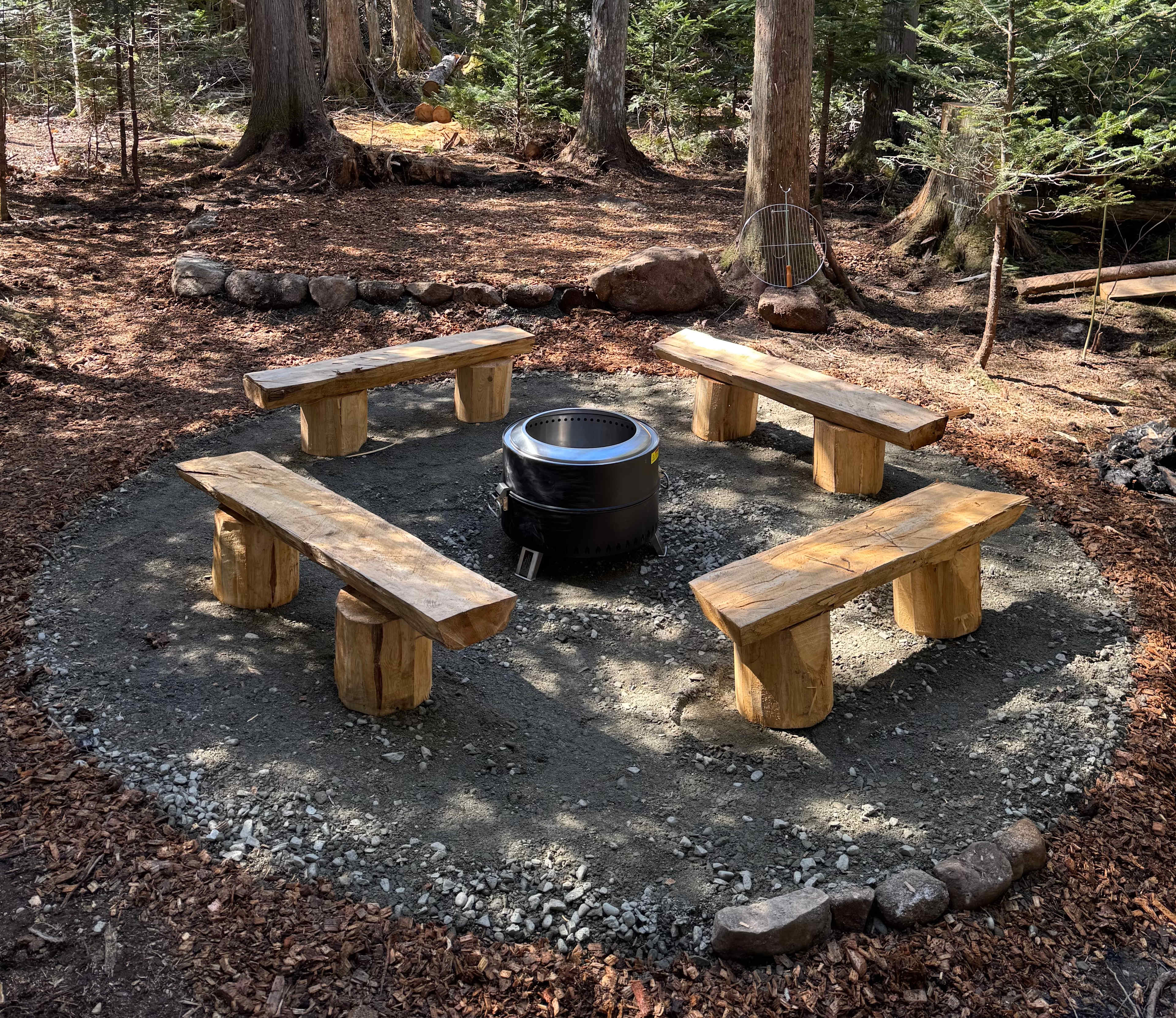 Smokeless bonfire pit with benches. These aren’t truly smokeless but they do reduce smoke and sparks and have a grill that fits right in them. 