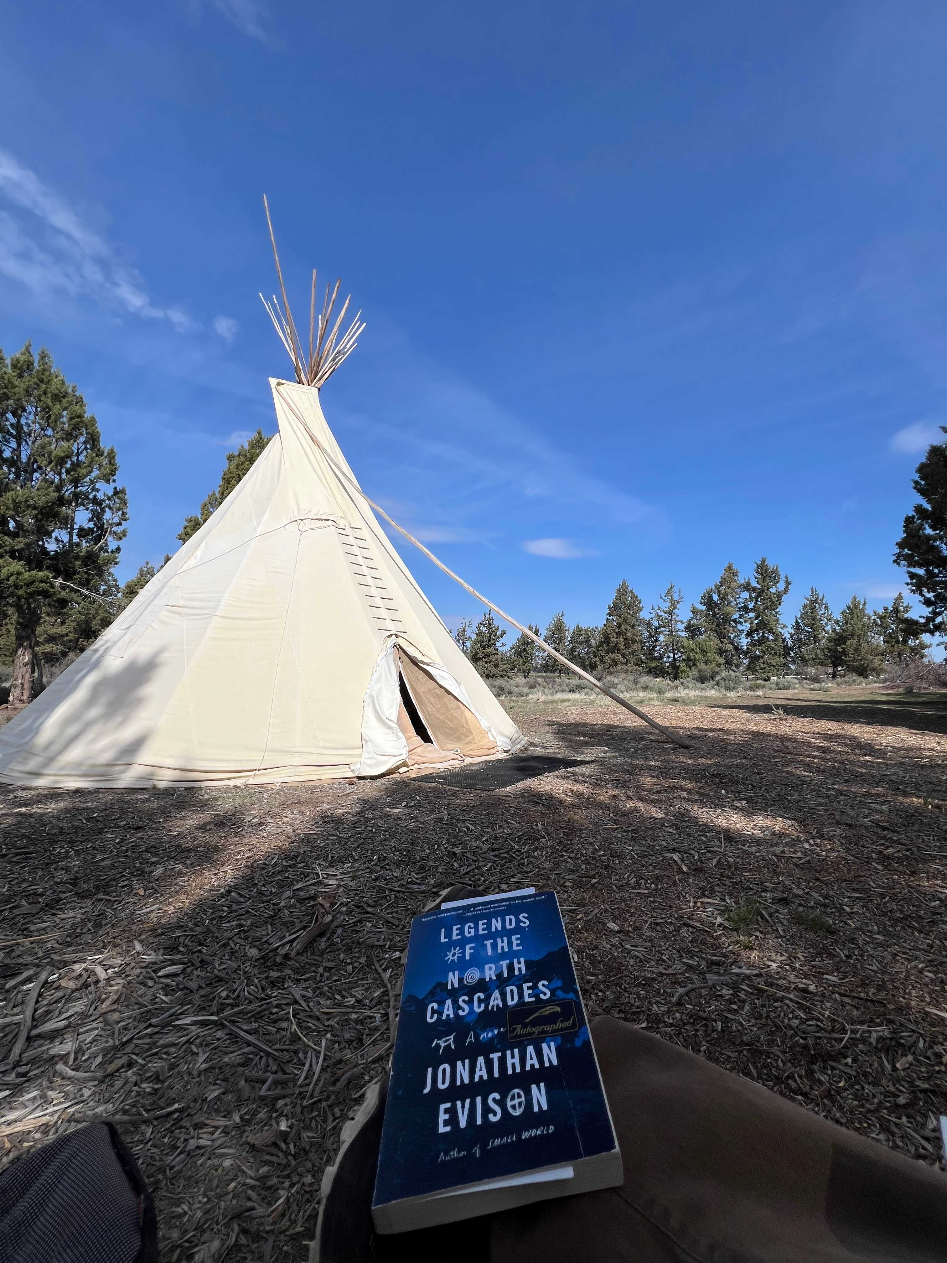 Enjoying a morning read outside the tipi. 