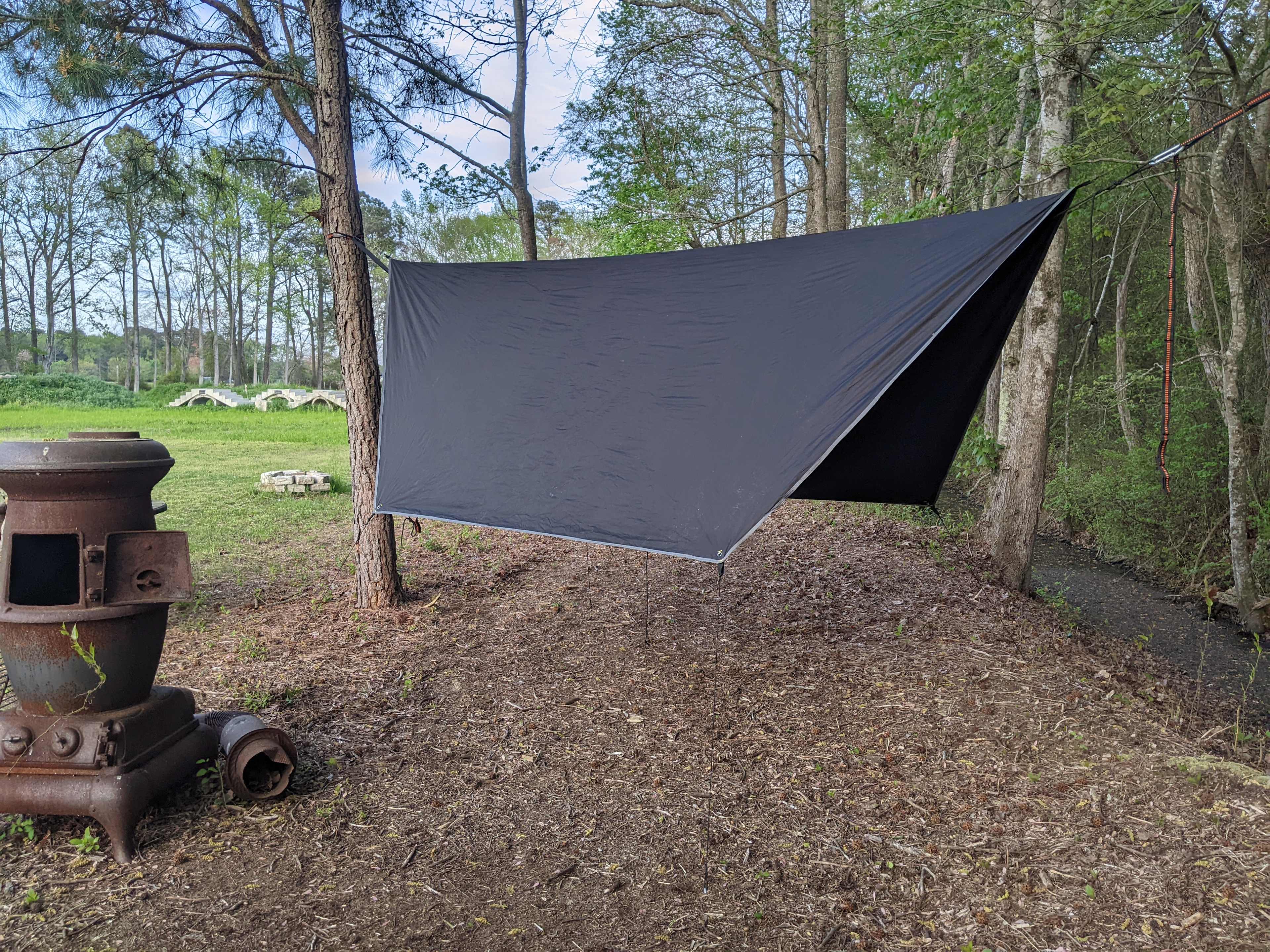 Camping hammock setup along the tree line.