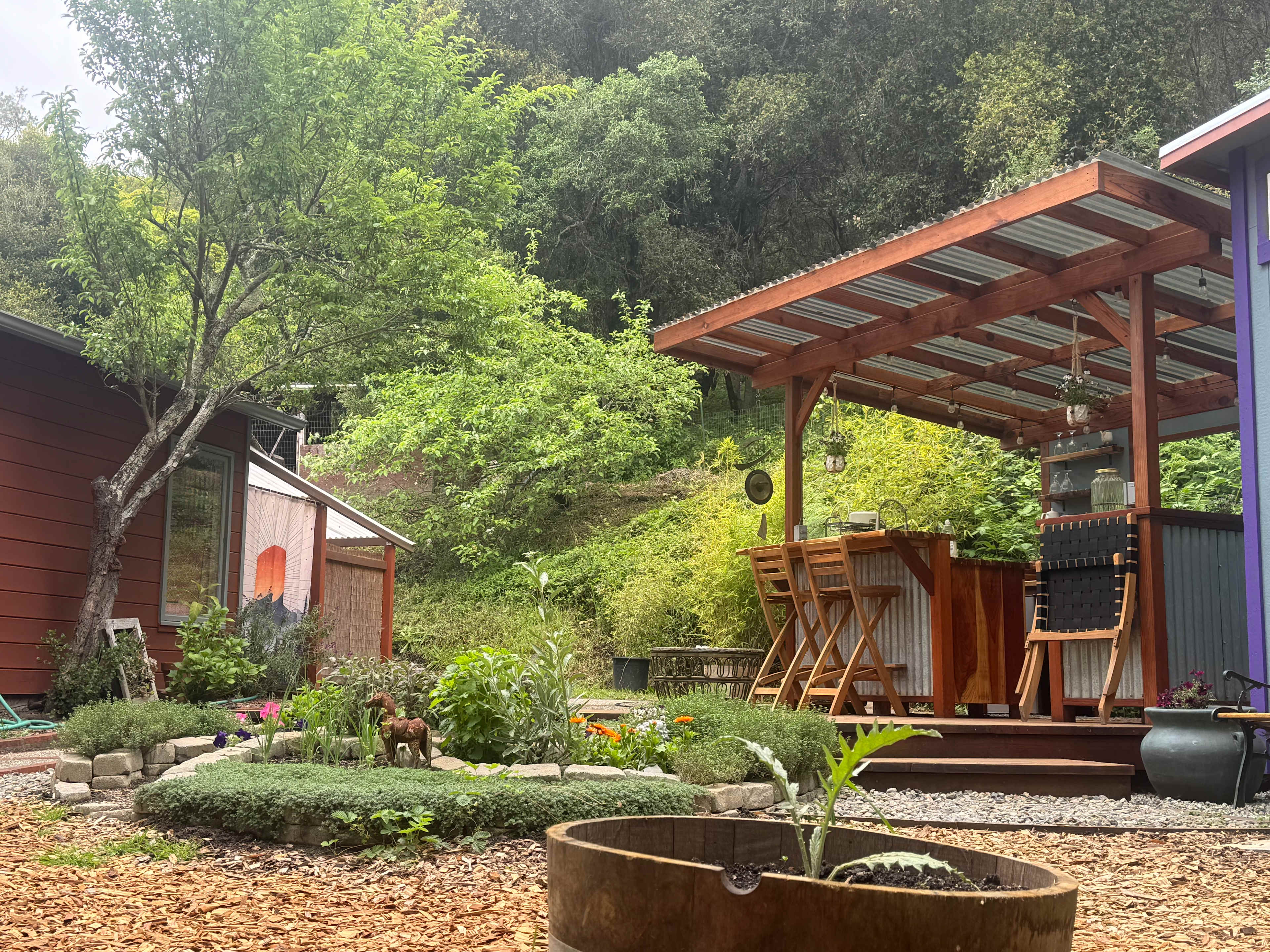 View of Kitchenette, herb garden, and outdoor shower area.