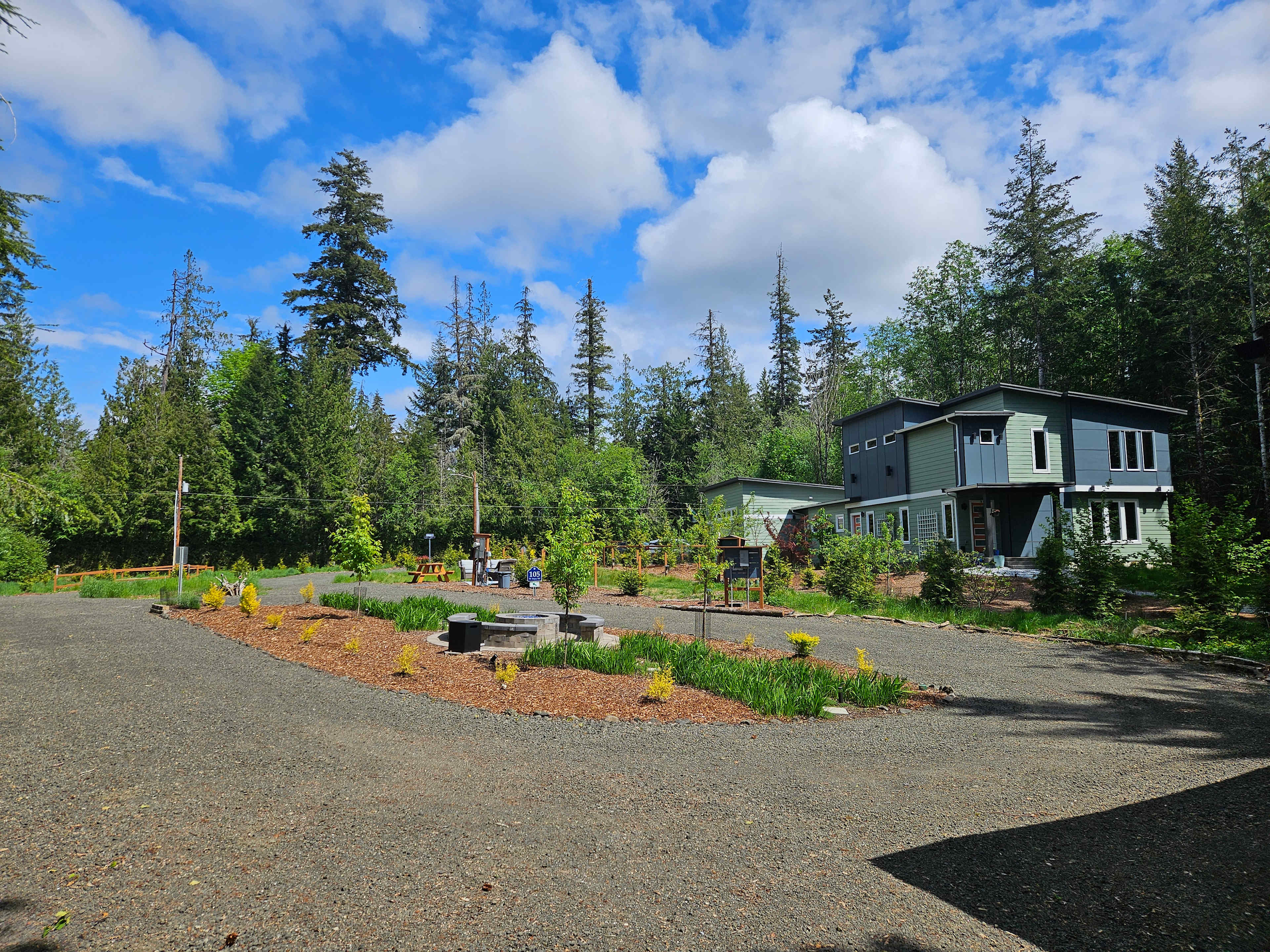 Driveway circle fire pit and RV site viewed from location of 1-bed/1-bath cottage