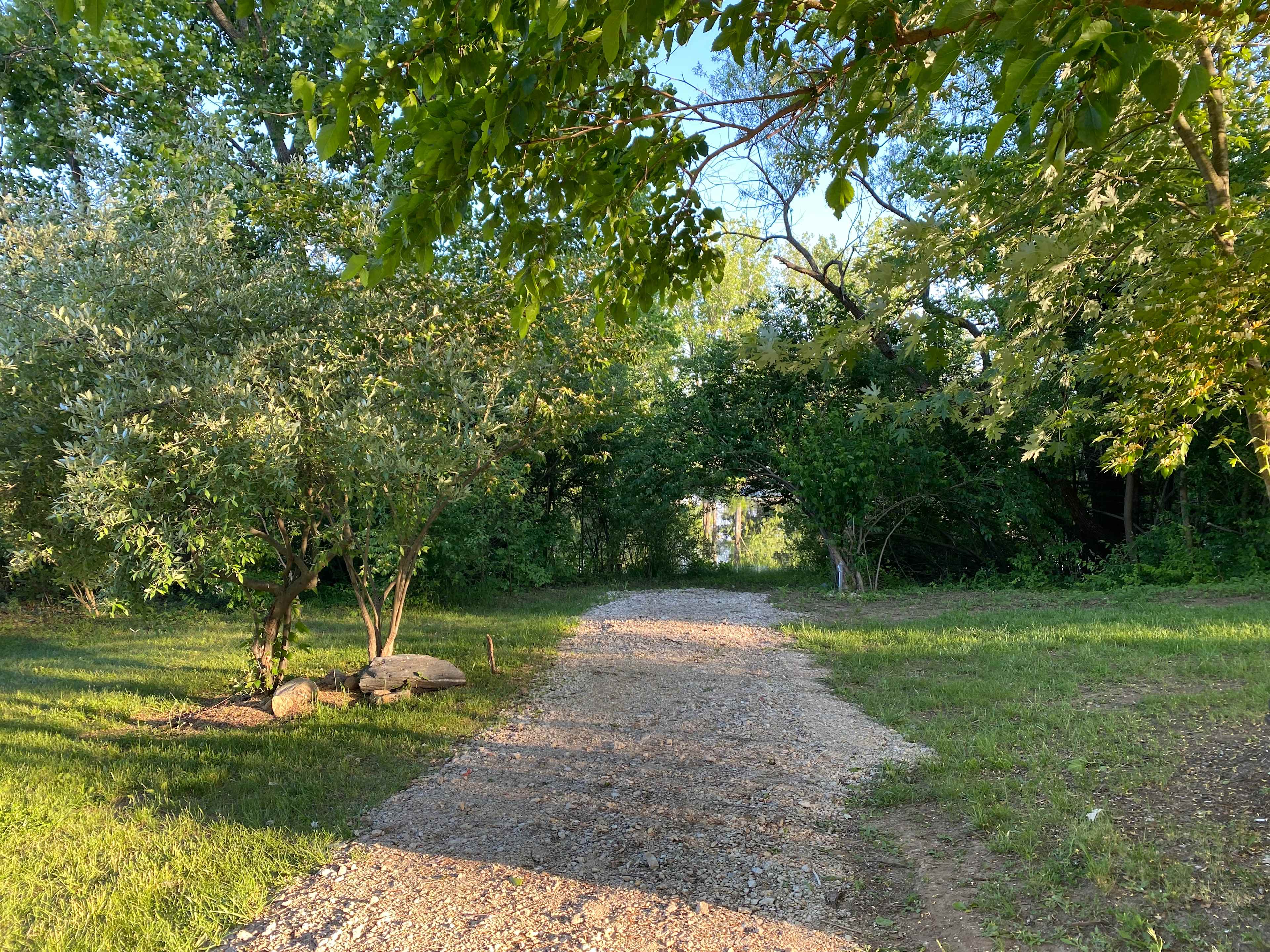 Waterfront campsite location situated at the bottom of the hill. Adjacent to former stone quarry rocky edge with ease of access to fish (catch and release), relax by the fire pit, enjoy the outdoor dining area and more. 