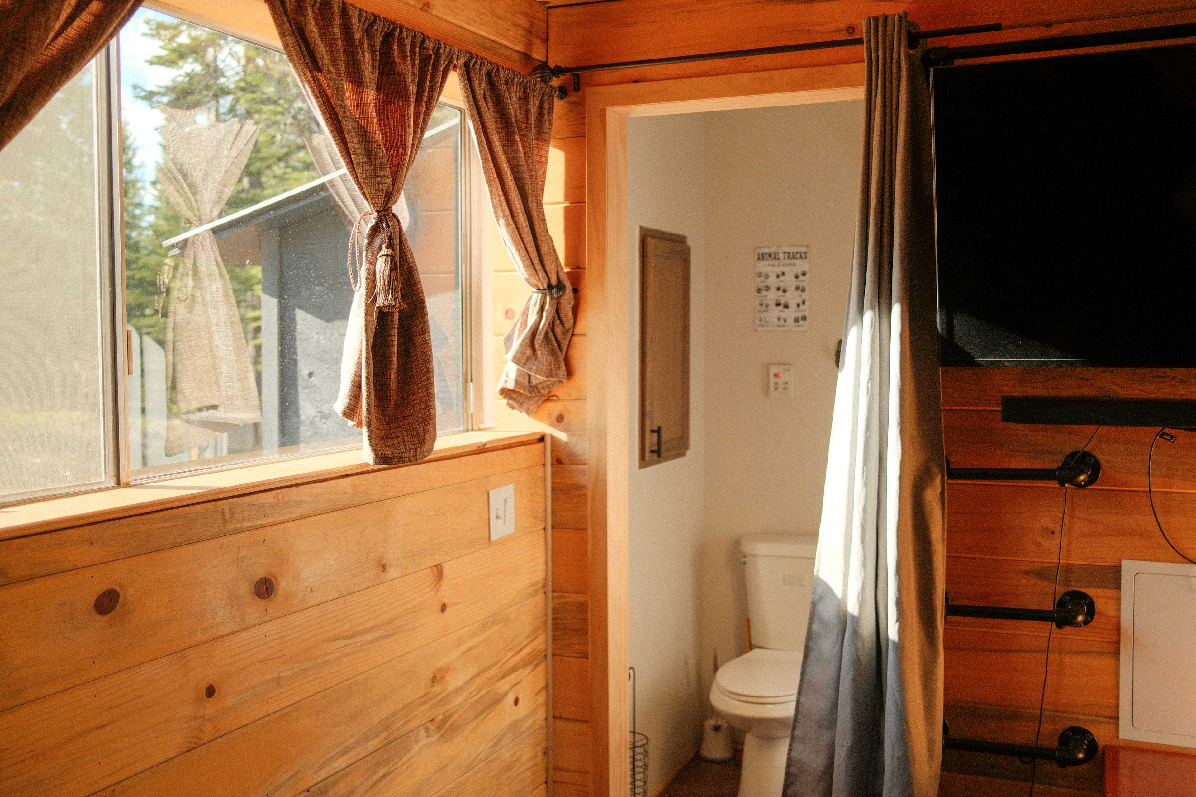 The bathroom has a flush toilet, shower, and sink