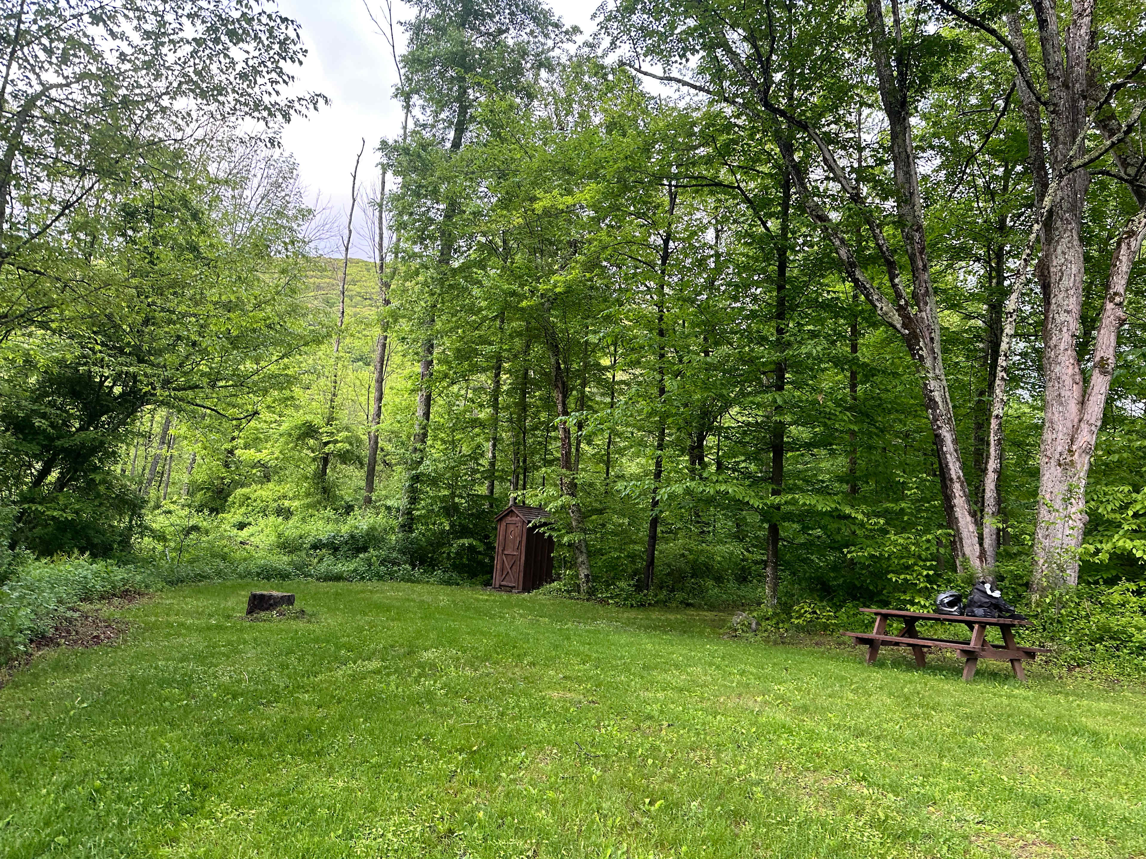 Outhouse, table, and high land for tents
