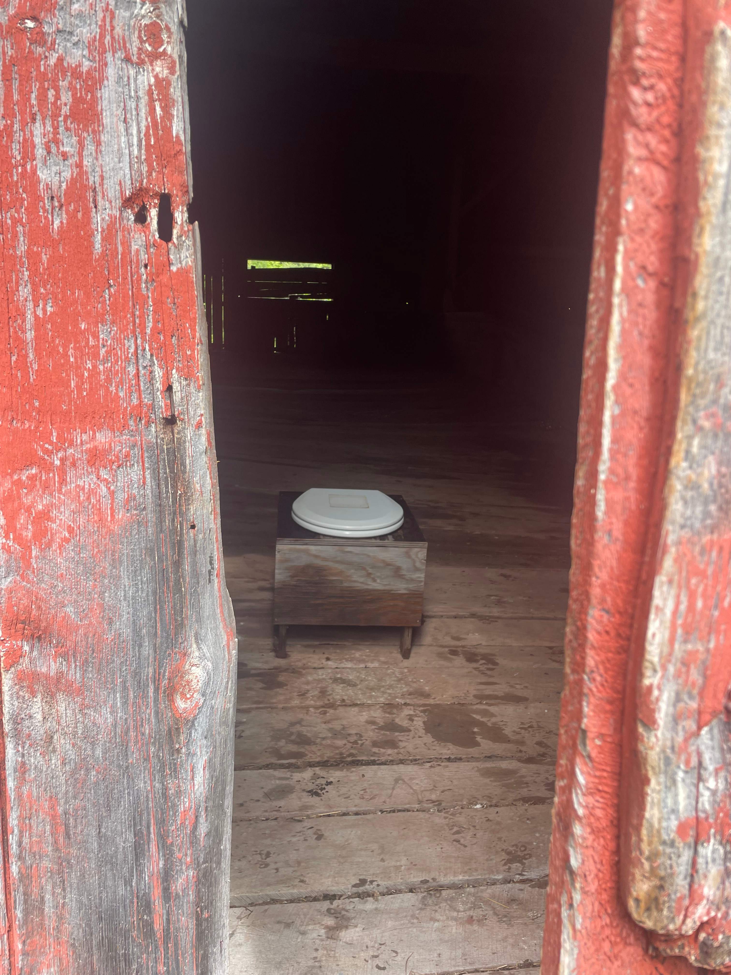 Rustic “hidden” barn outdoor toilet, was a peaceful view looking 