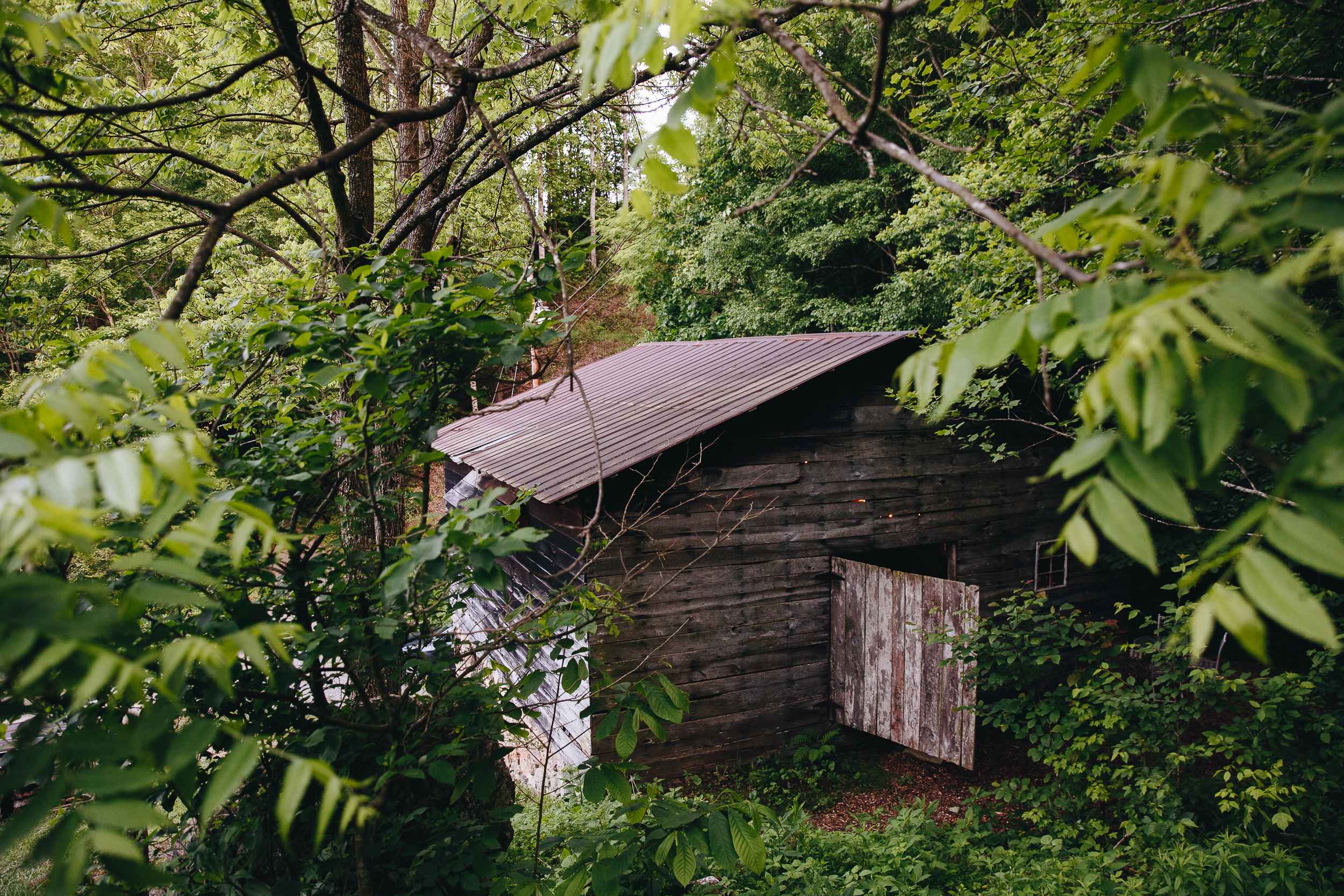 Front door tucked on the backside of the tobacco barn.