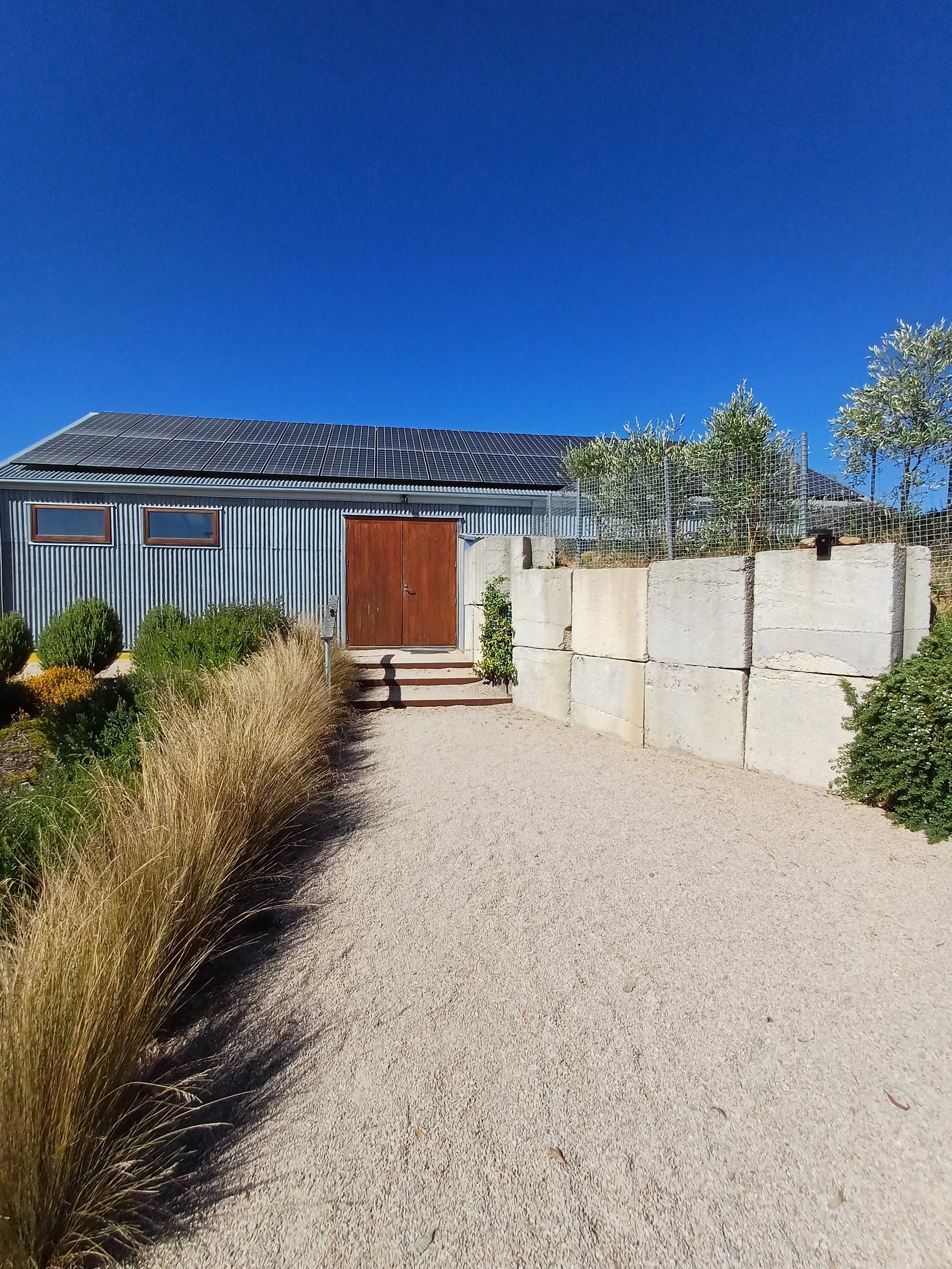 Zero net carbon cellar door front. We export three times the amount of electricity we use. We designed the building to be energy efficient.