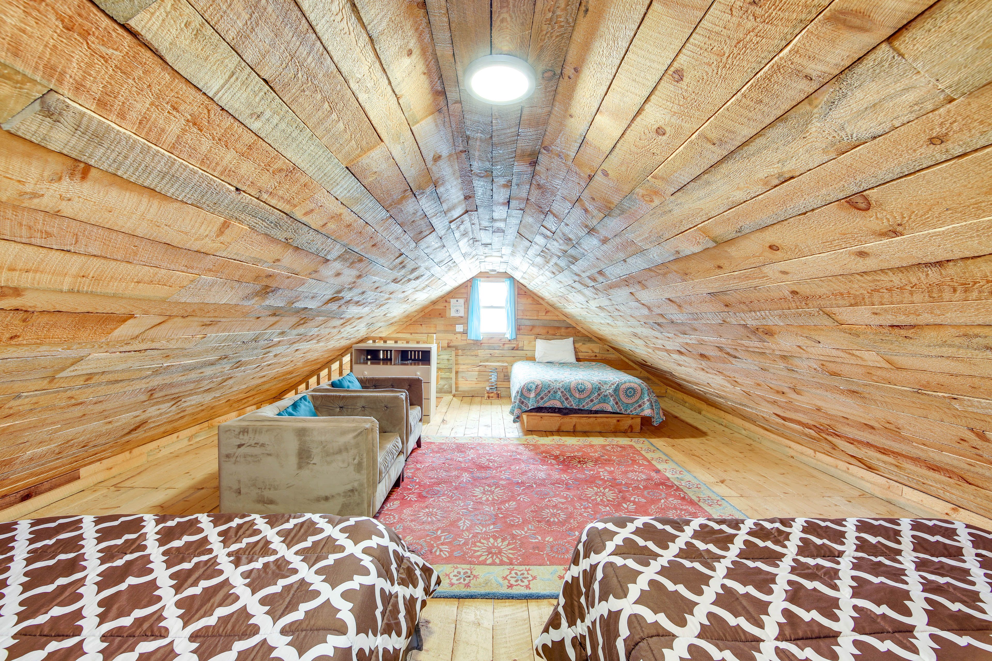 The spacious loft also has a couple of comfy chairs to relax and read a book.