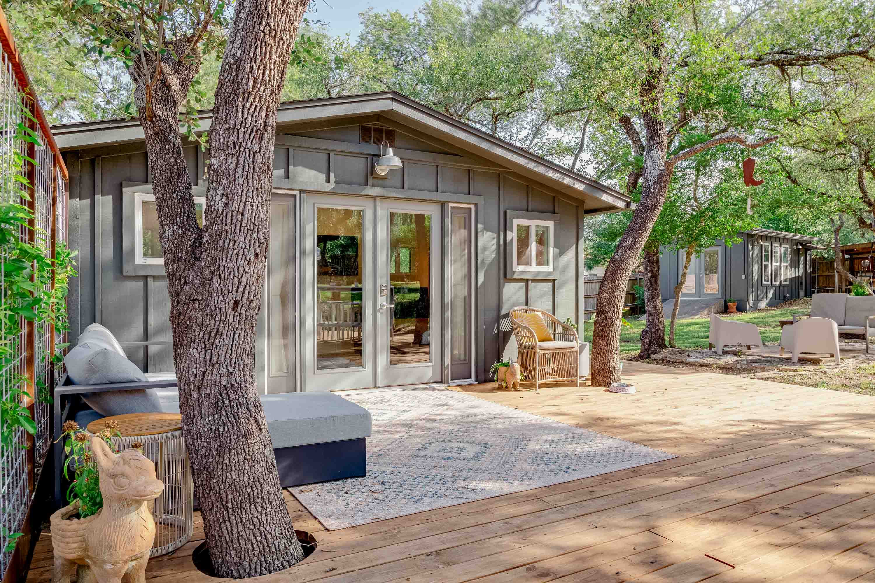Charming exterior view showcasing the cozy seating area beside the building — perfect for relaxing outdoors.