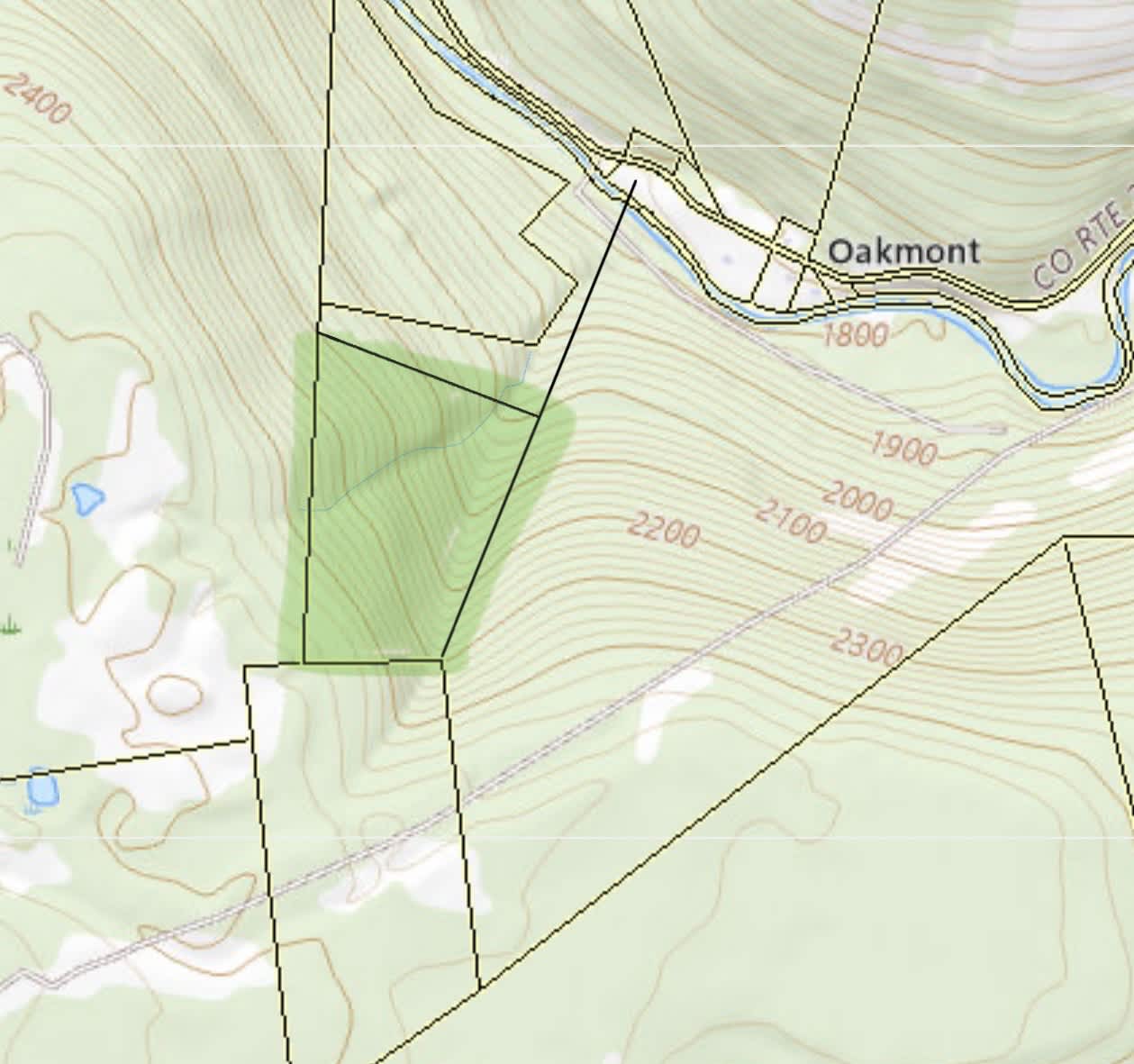 The blue line on this topographical map indicates the stream running through the property and the property boundaries. 
