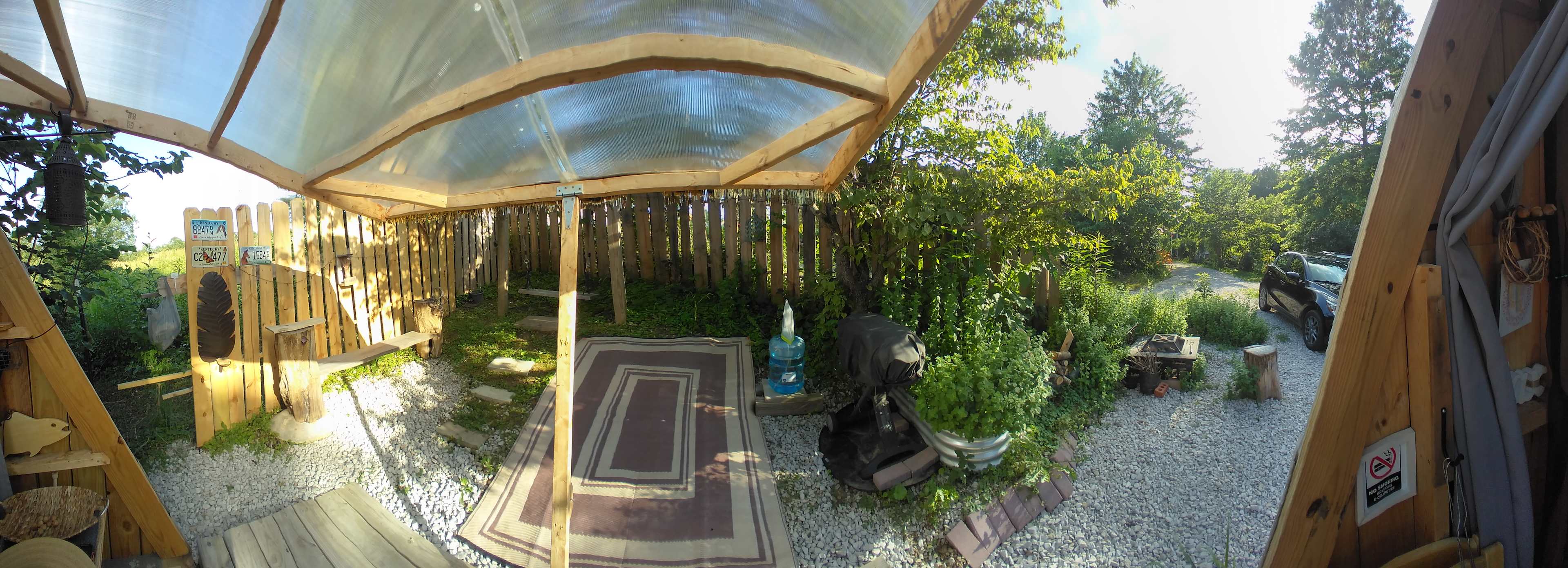 Panoramic view from standing in the cabin looking out the open side -- note that this makes the site look bigger than it is, but I just wanted to capture how much you are privately enclosed on that side from neighbors.