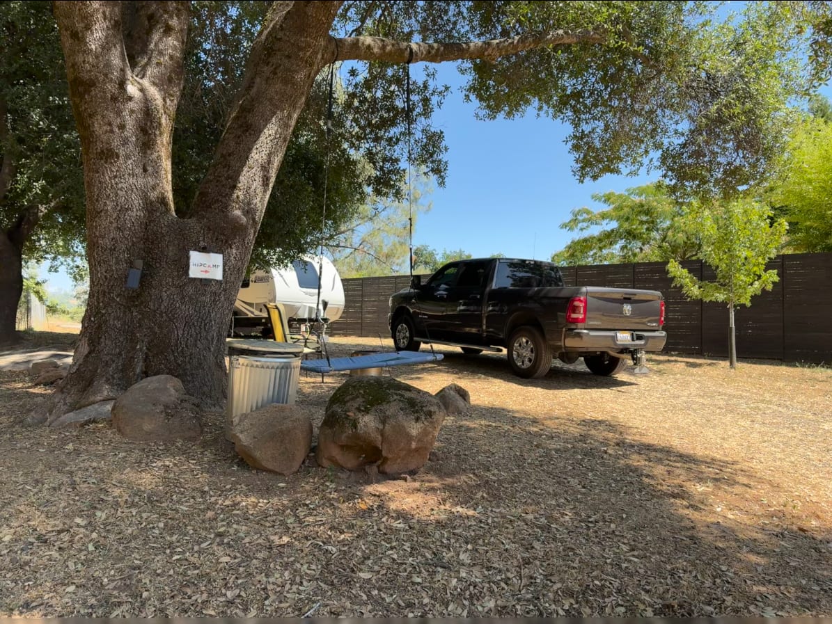 Fire pit, swing, chairs, and trash.  Site is very long and mostly level