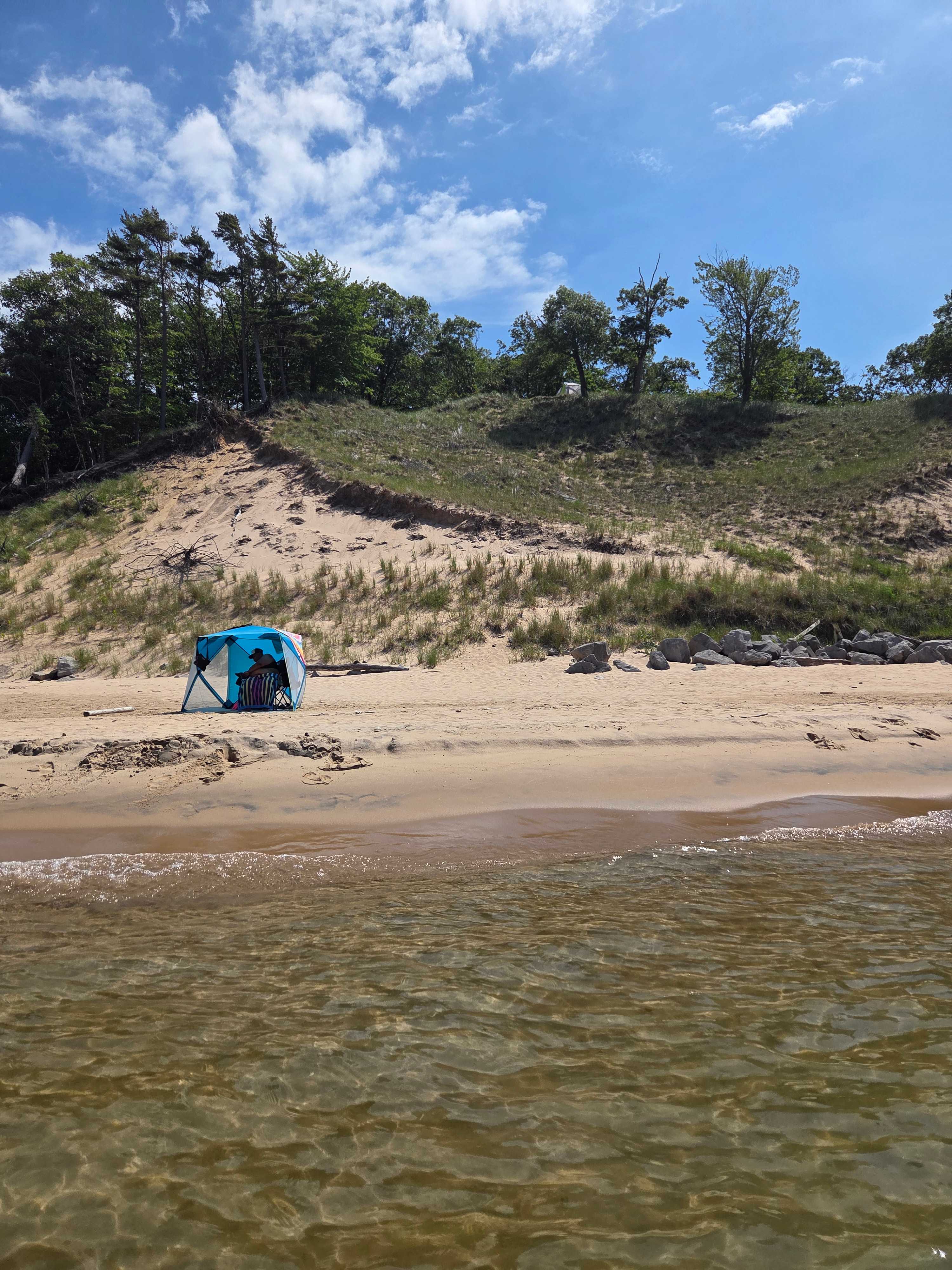 Tent on bluff under the tree.