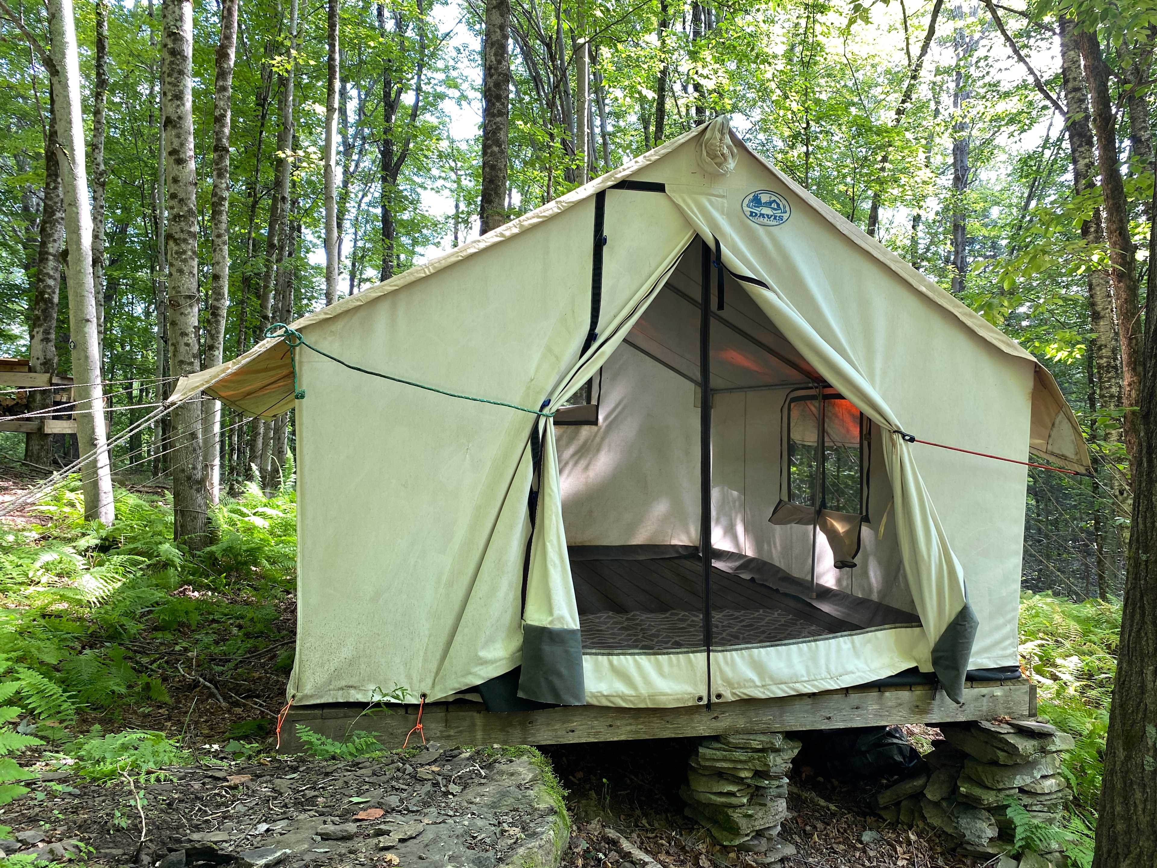 Secluded, wooded, lush site adjacent to a peaceful waterfall stream. The 10x12 canvas expedition tent is perched on a homemade platform ready to enjoy. 