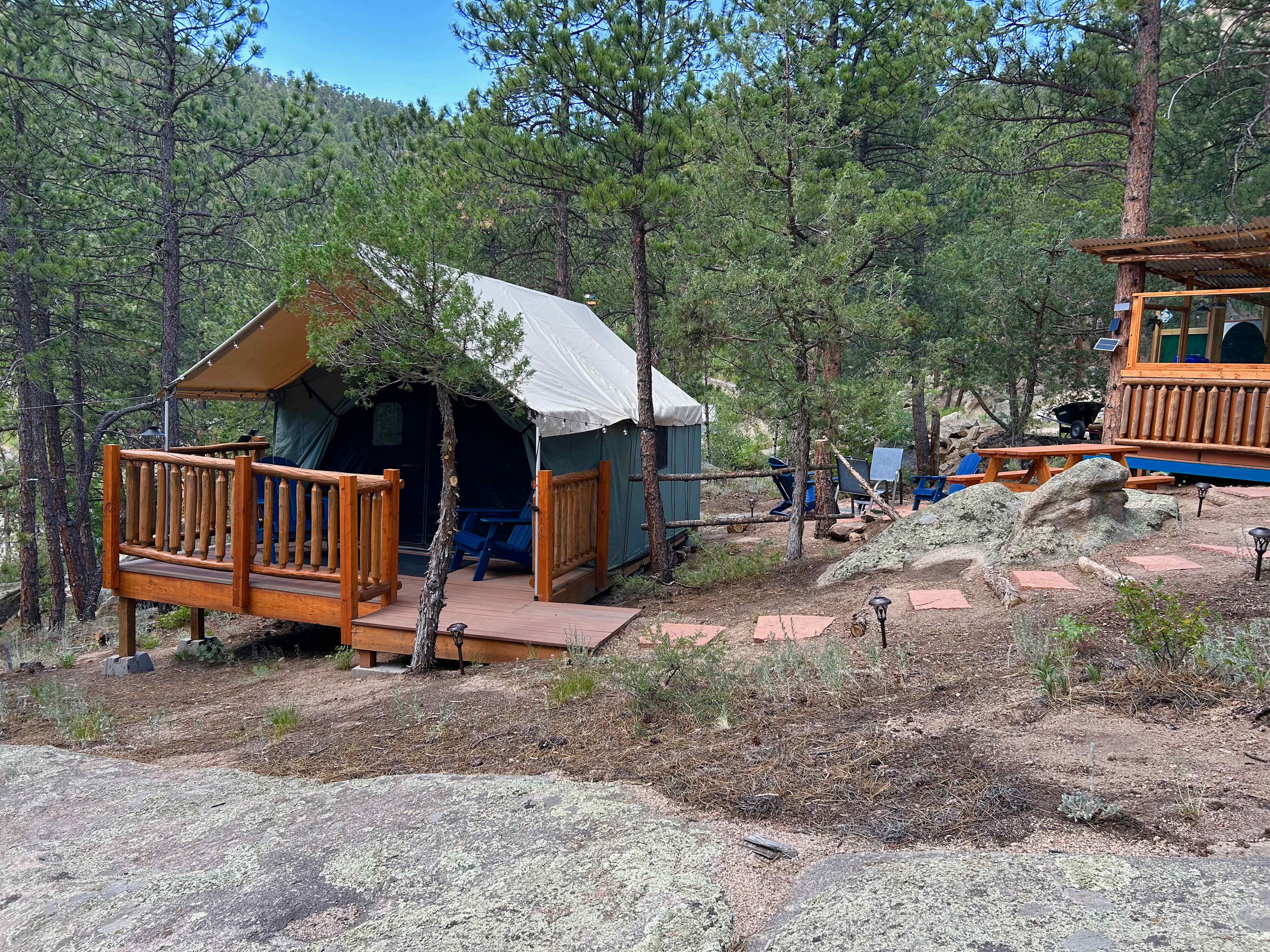 The new 12' x 14' Explorer Tent with outdoor kitchen and propane campfire