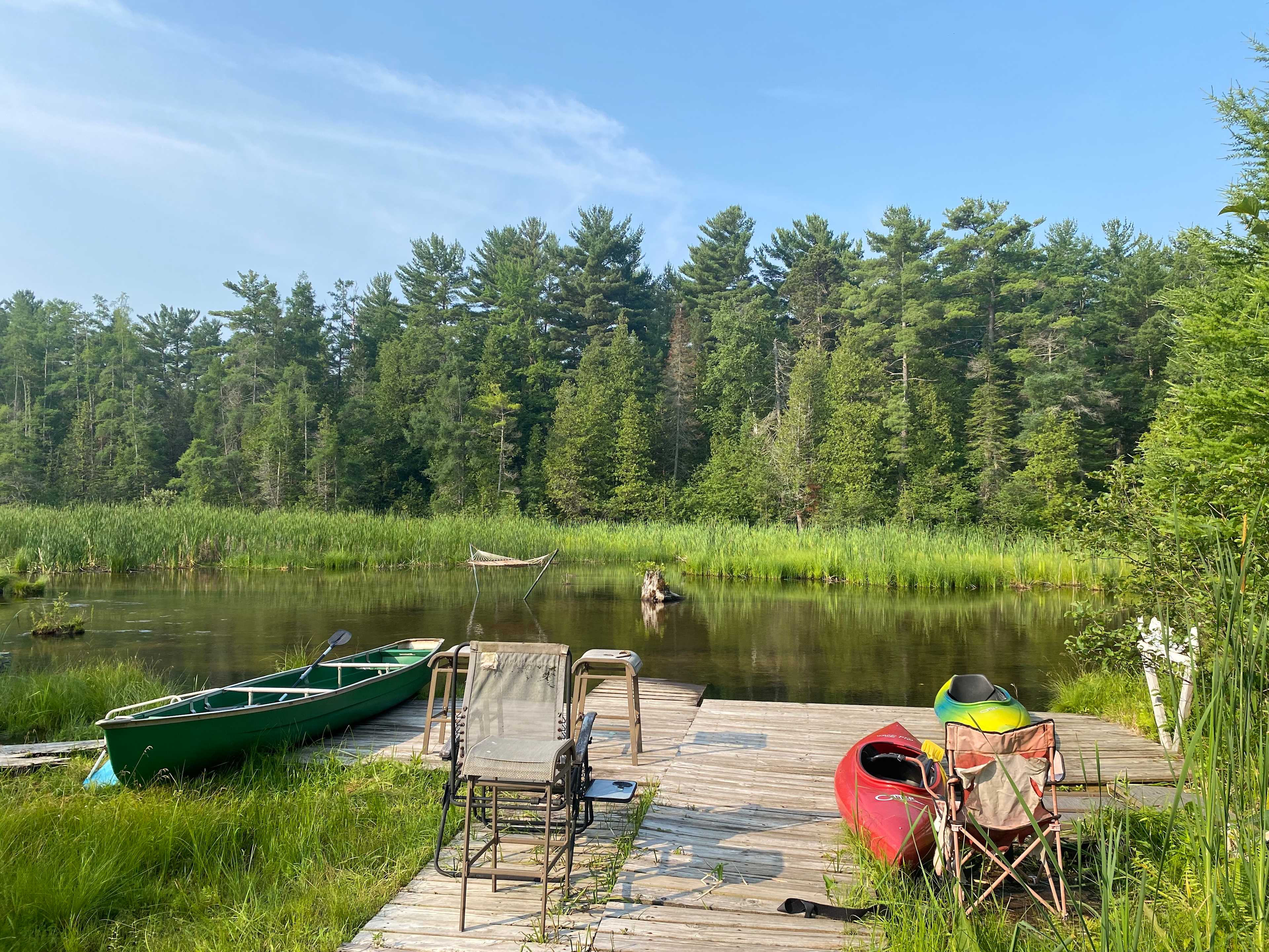 View from the dock - 3 kayaks - 1 canoe (3 paddles) a few old chairs provided. Note that it is very shallow 