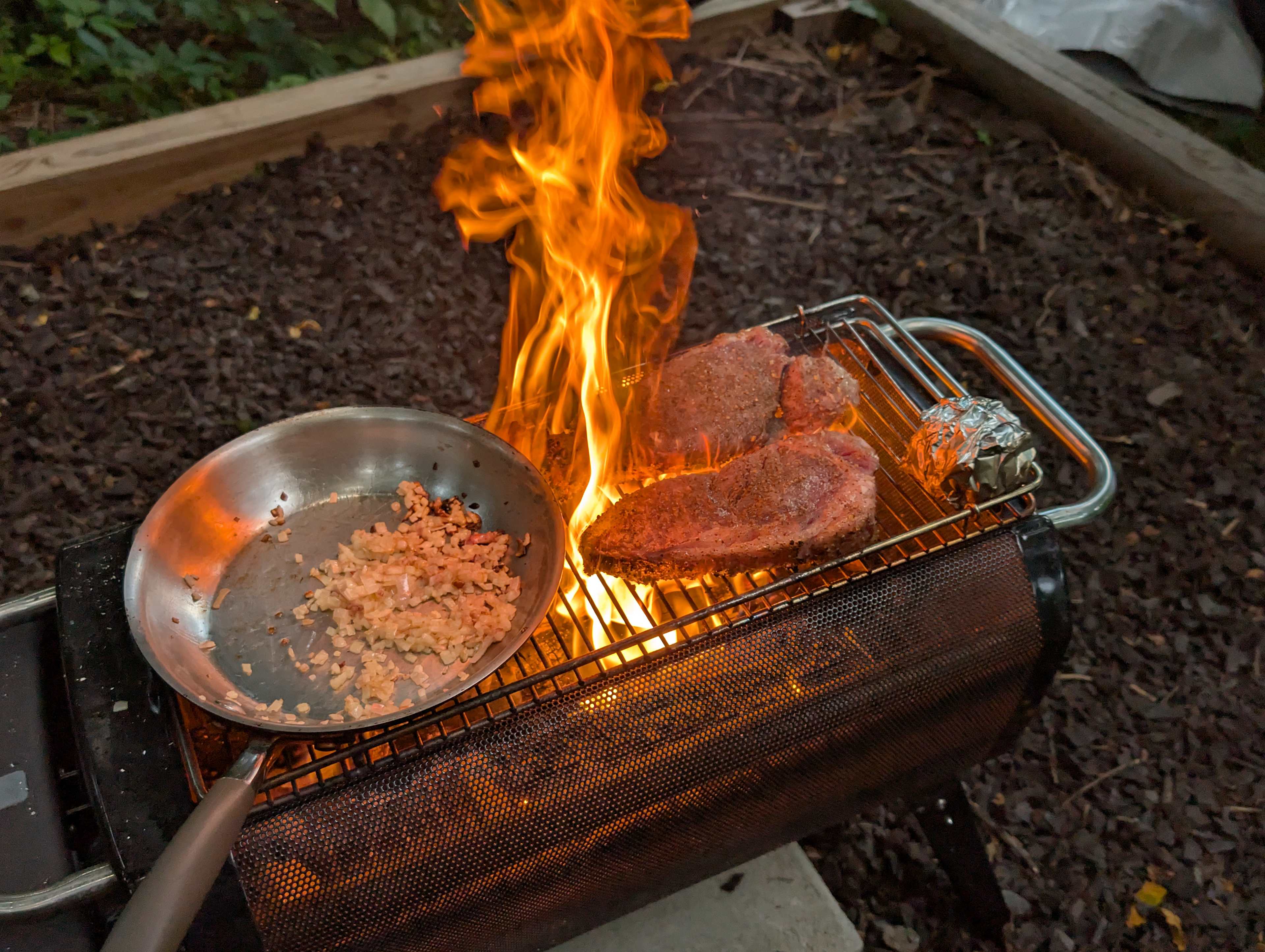 Host Pan fits great on the grill, with room for steaks. Fantastic fire pit ready for cooking
