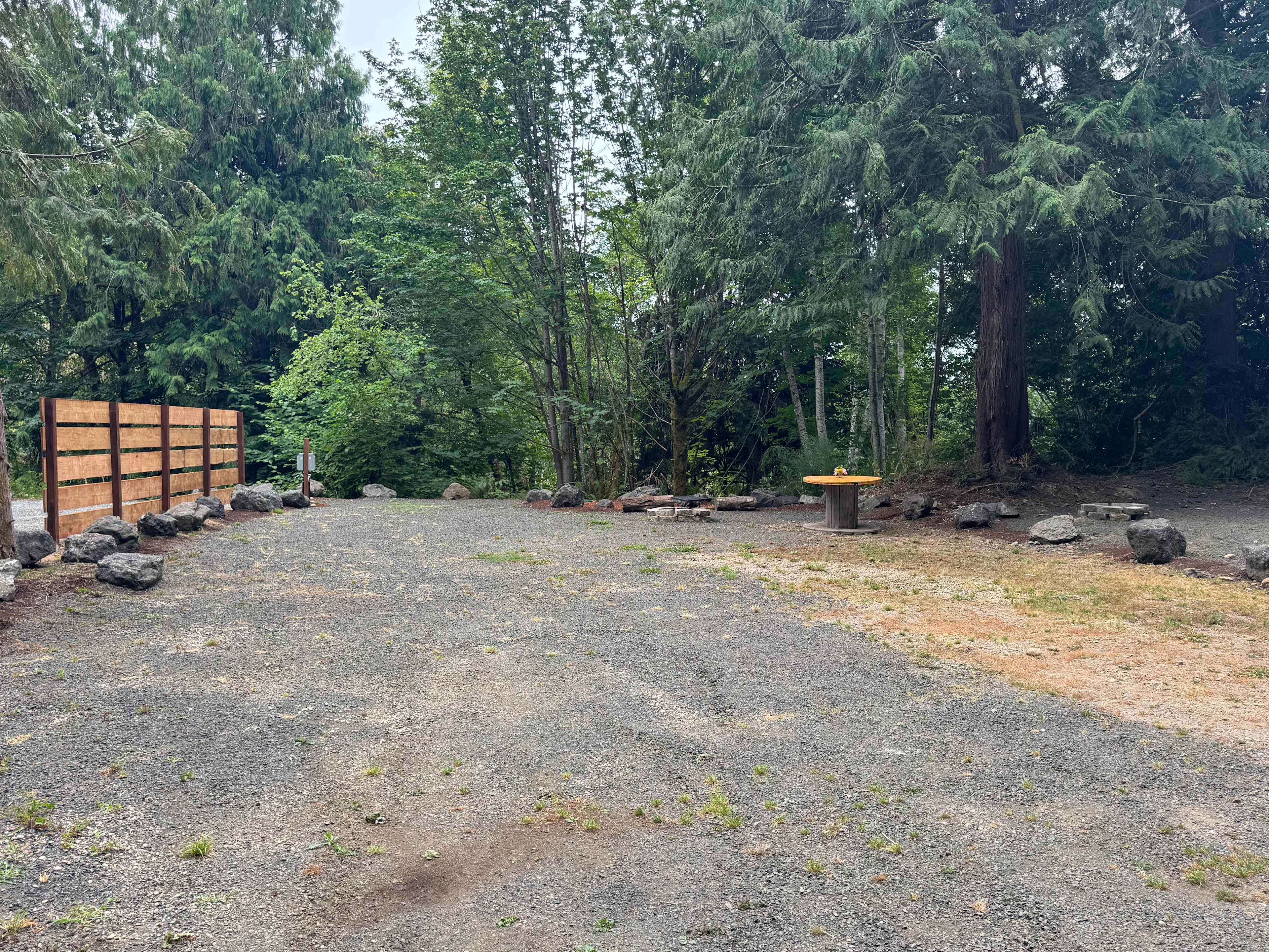 Site #2 sits directly adjacent to Site #1 and their border is delineated by the cedar fence on the left. Site #3, on the right of Site #2 is not open for reservations.